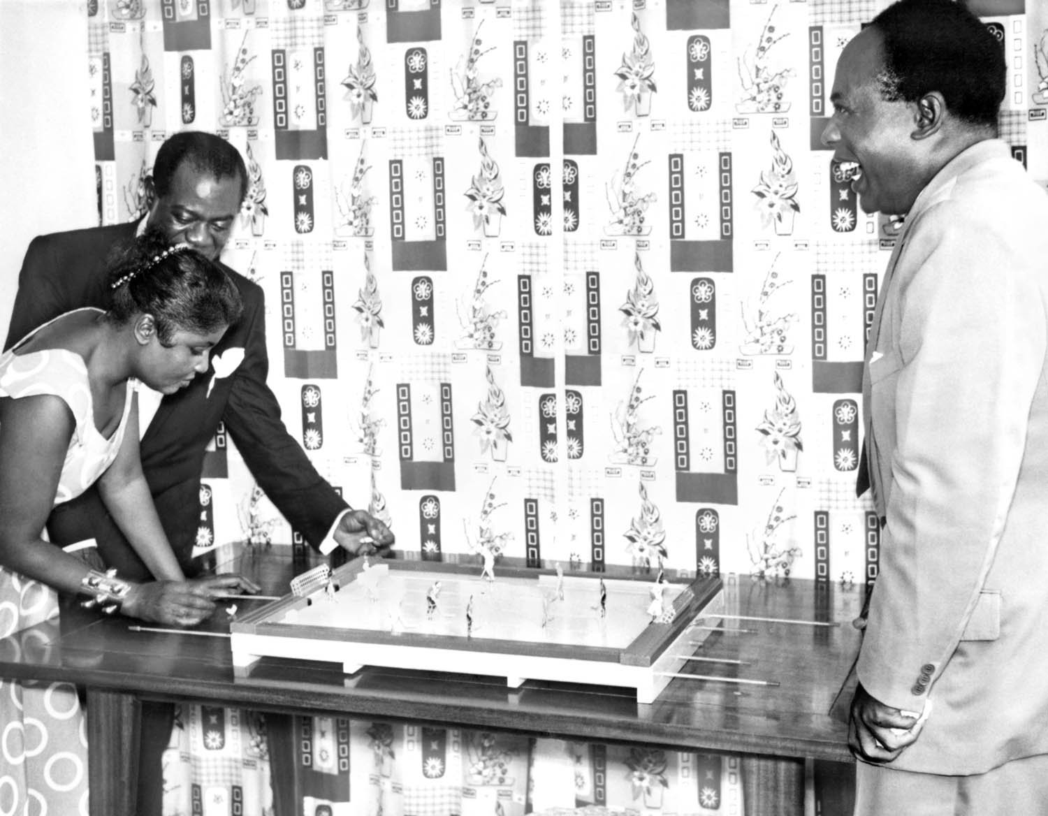 Louis Armstrong and his wife Lucille play miniature hockey with the first Prime Minister of Ghana. Accra, Gold Coast, 1956. Courtesy of the Louis Armstrong House Museum.
