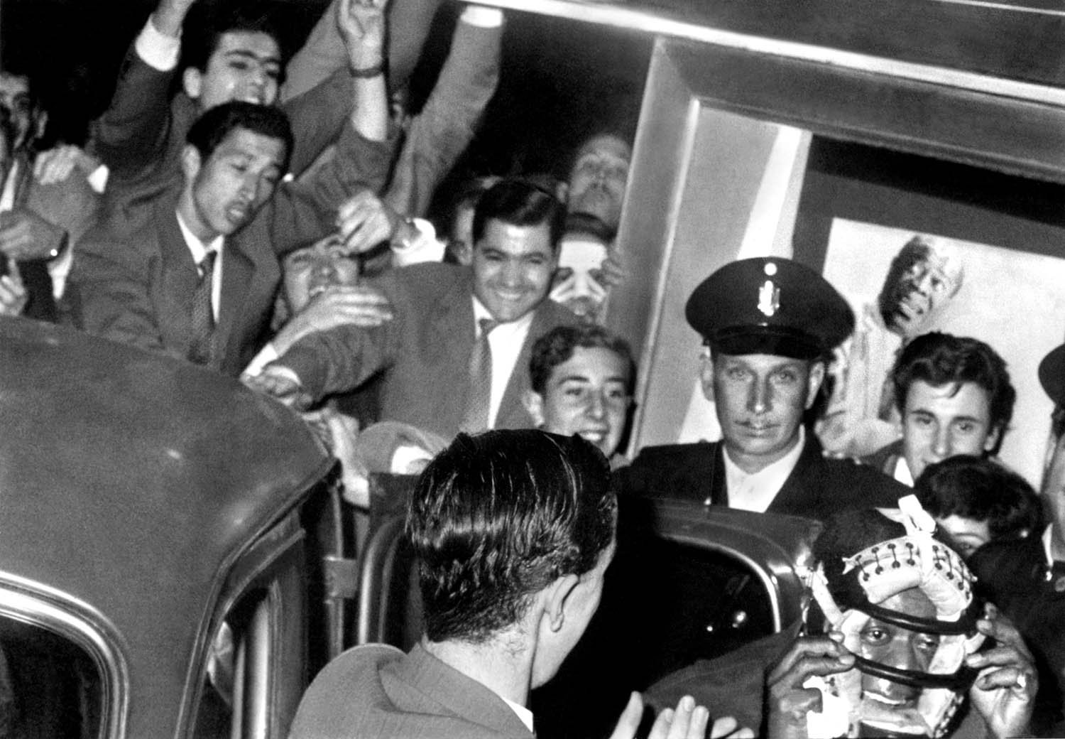 Louis Armstrong wears a catcher’s mask to protect himself from enthusiastic fans. Buenos Aires, Argentina, 1957. Courtesy of the Louis Armstrong House Museum.