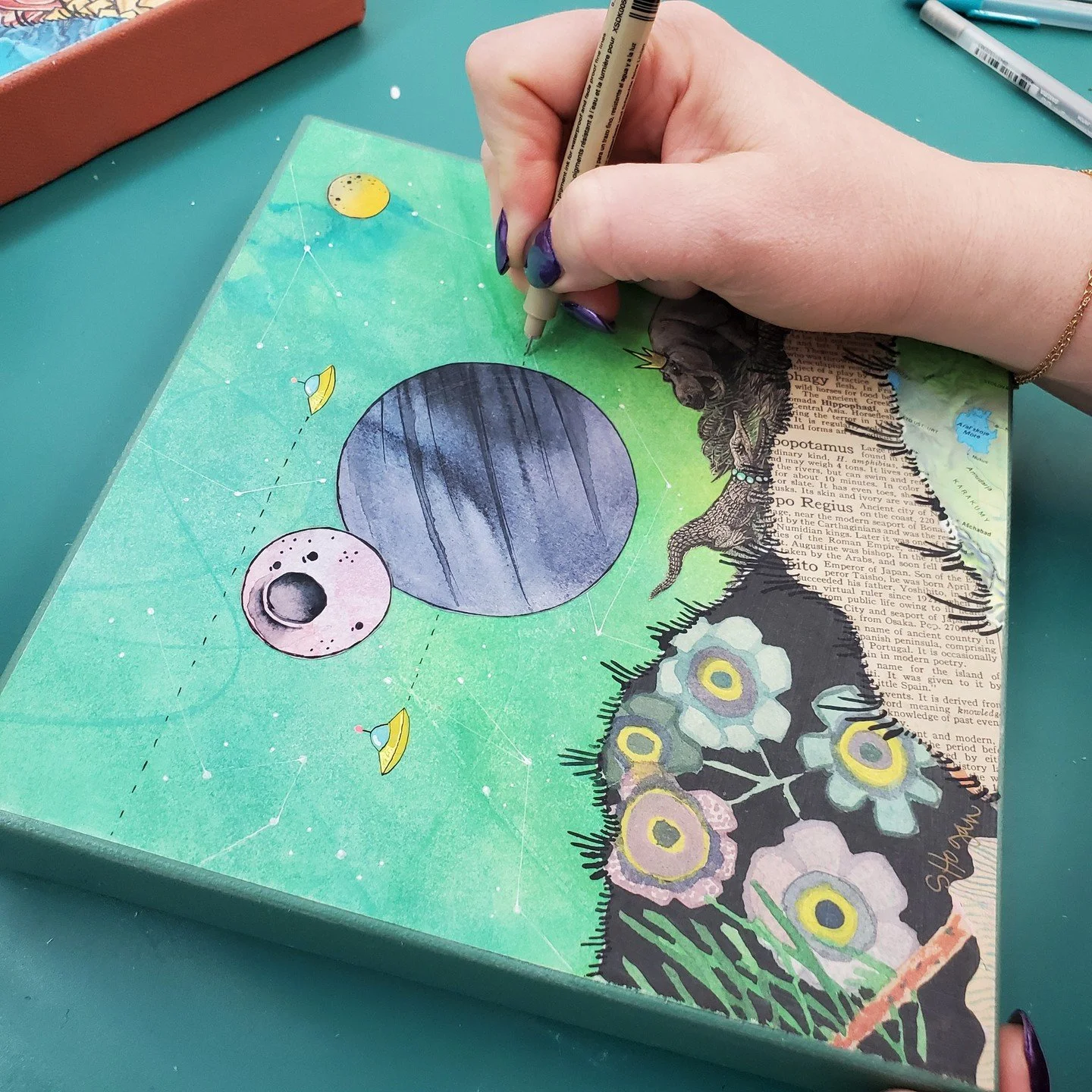 A behind-the-sceens look at just some of the steps in my creative process. Layers and layers of storytelling and silliness! ⁠
⁠
See this piece and many many more today at Summer Art Fair in Midland, Michigan. On Main Street until 5pm!