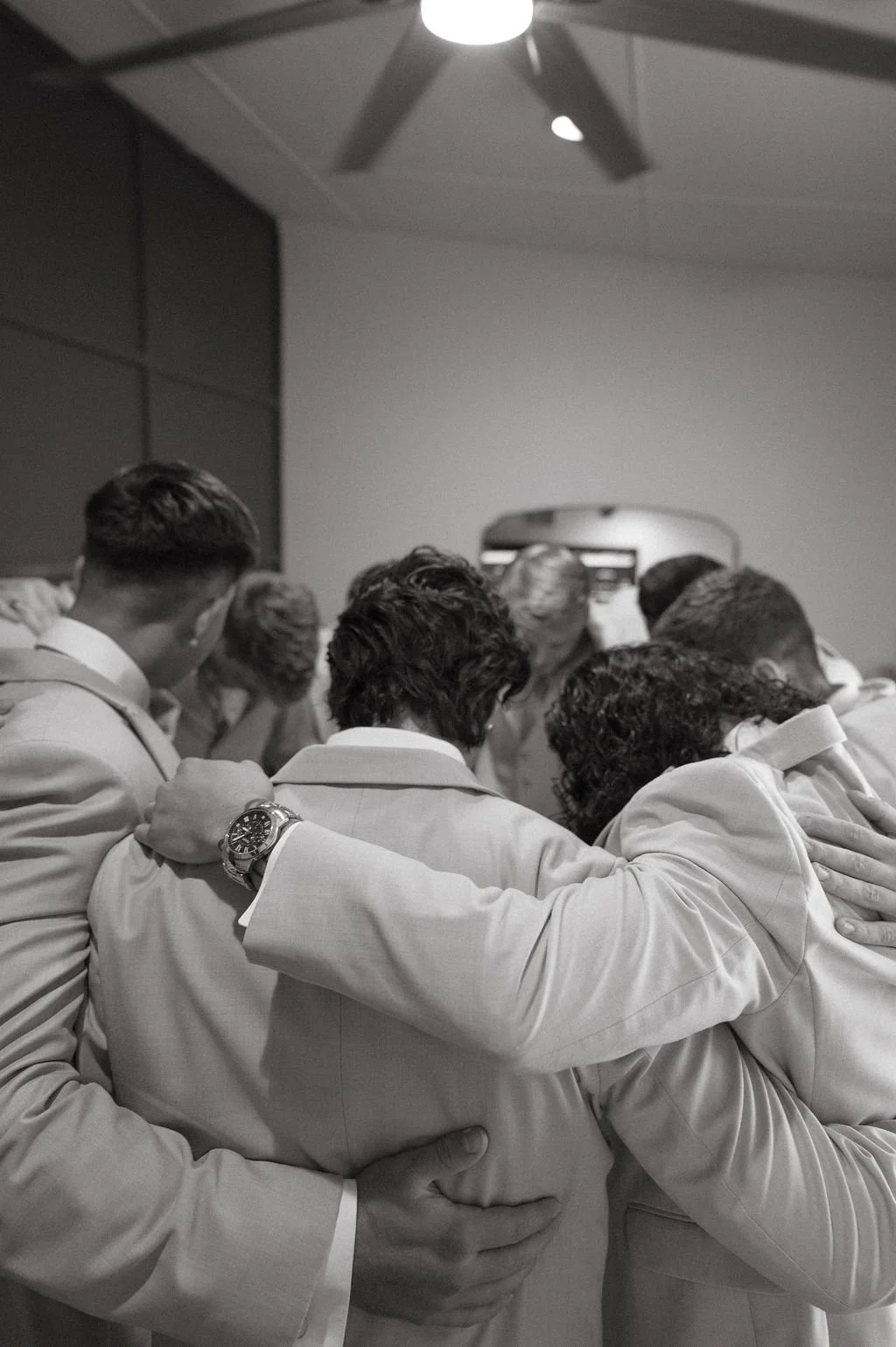 groomsmen praying before the ceremony