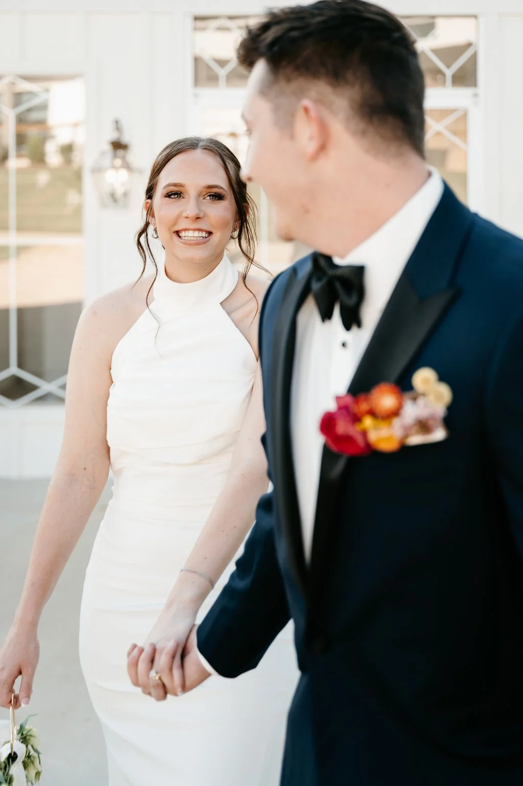 bride in a white dress smiling at her groom after they elope at sunset oaks venue
