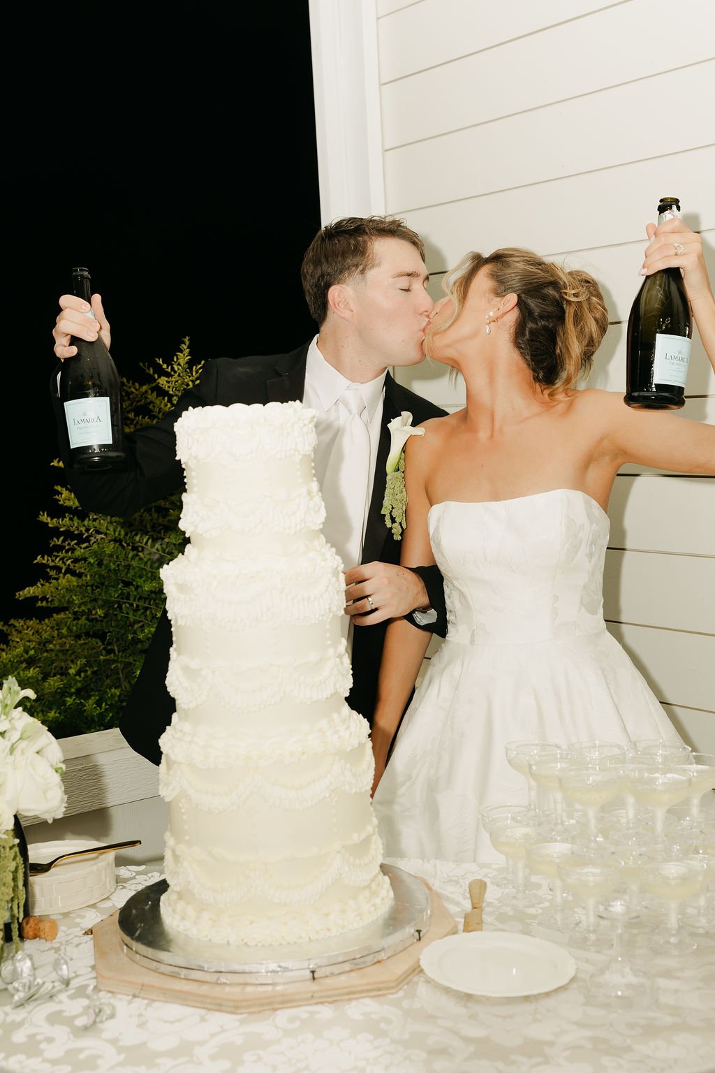 bride and groom toasting champage