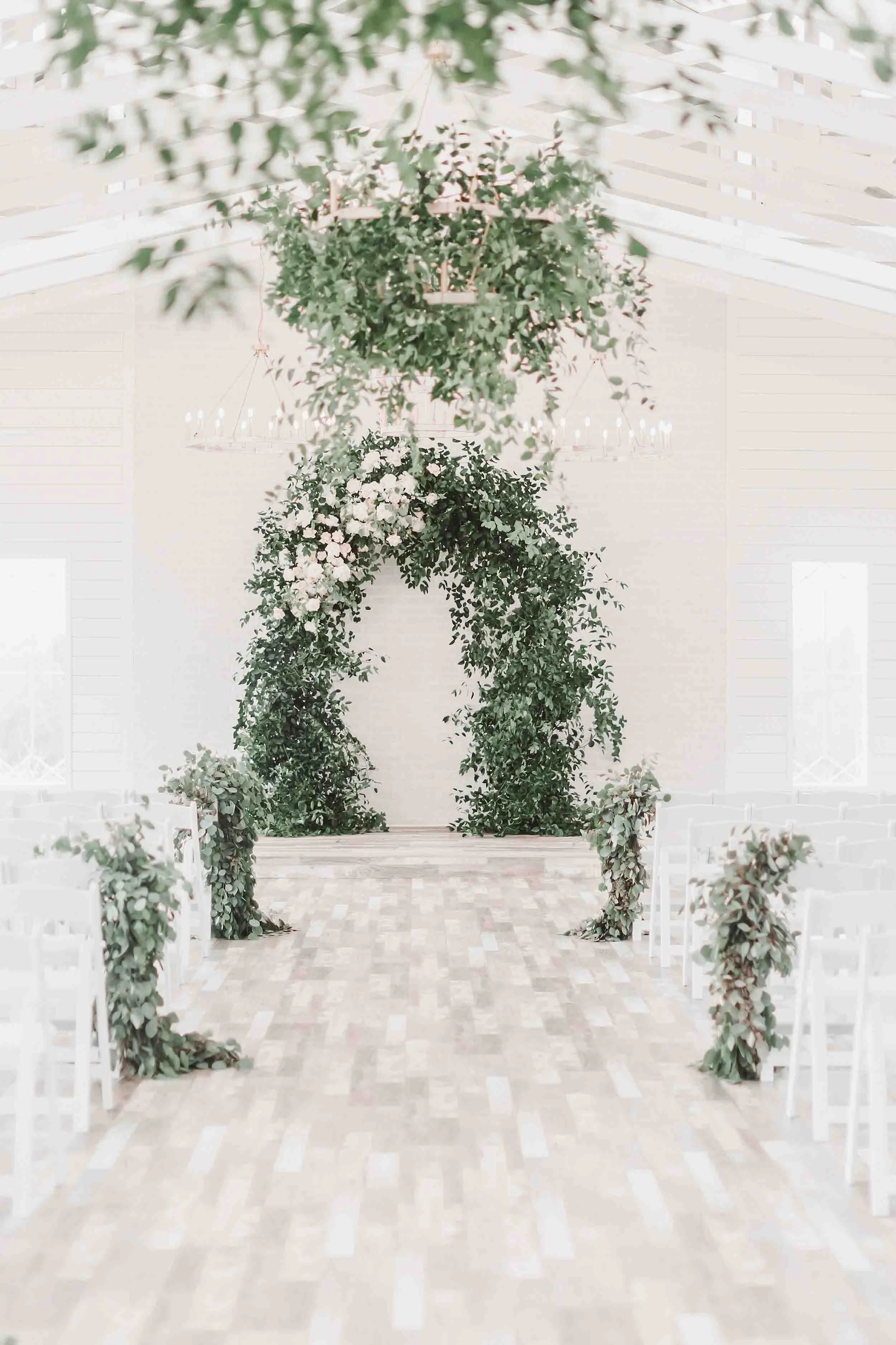 indoor wedding reception with flowers and greenery in east texas