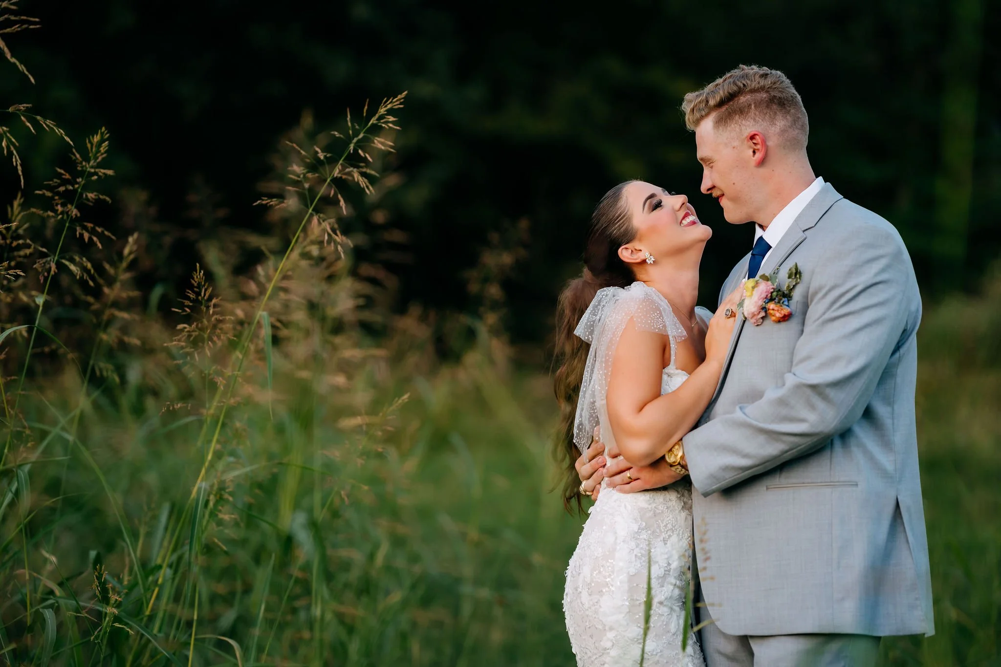 couples portraits in the tall grass at september wedding in texas