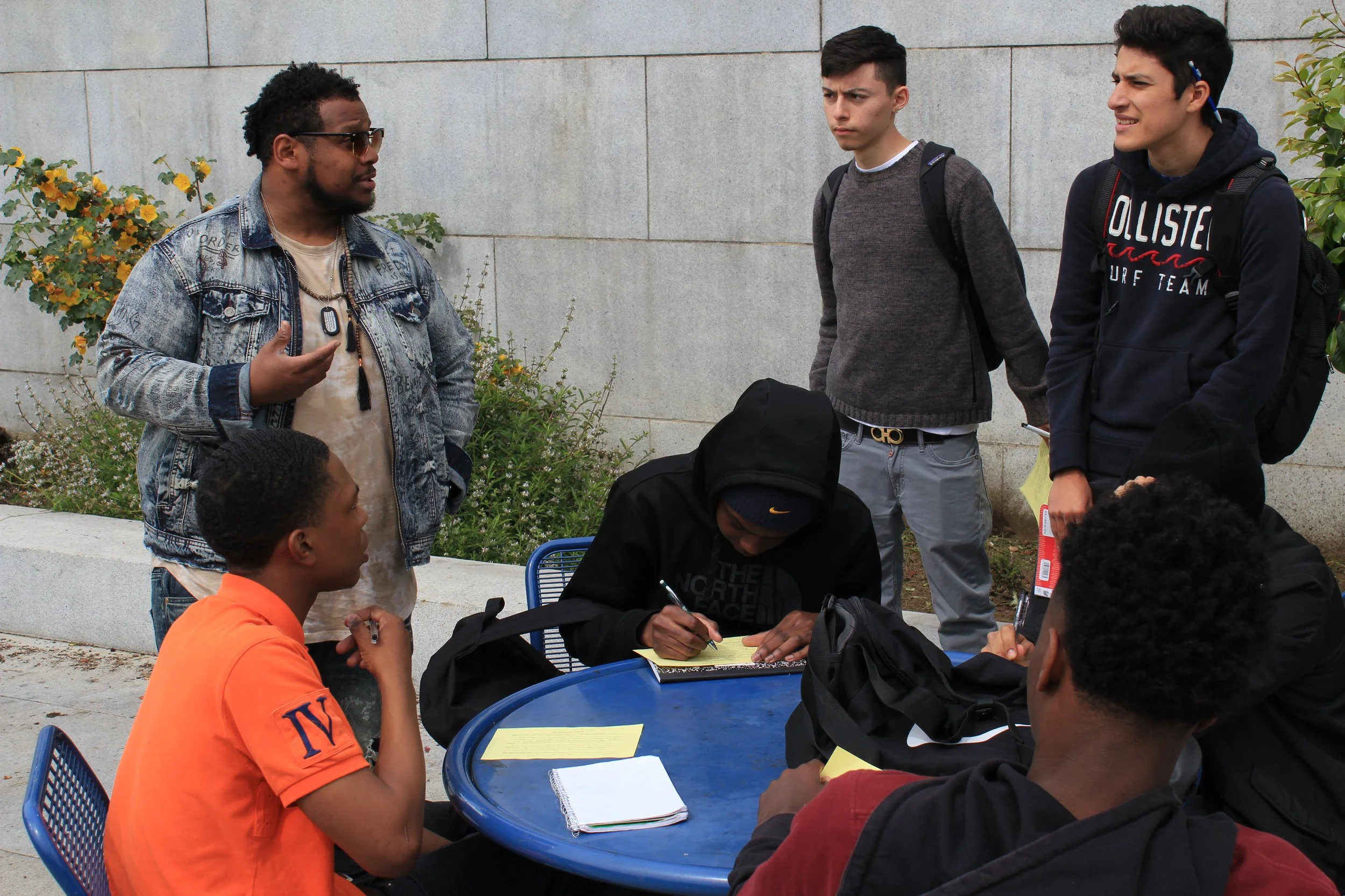 Teaching Artist Marlon Richardson works with students on chants and hooks. 