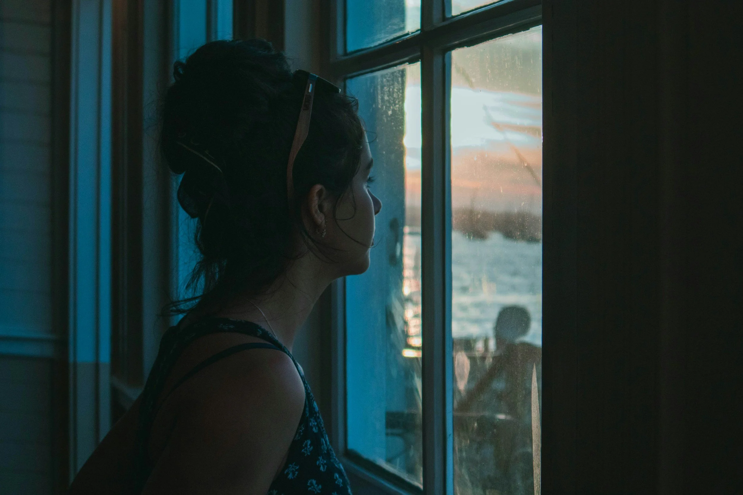 overwhelmed woman looking out window