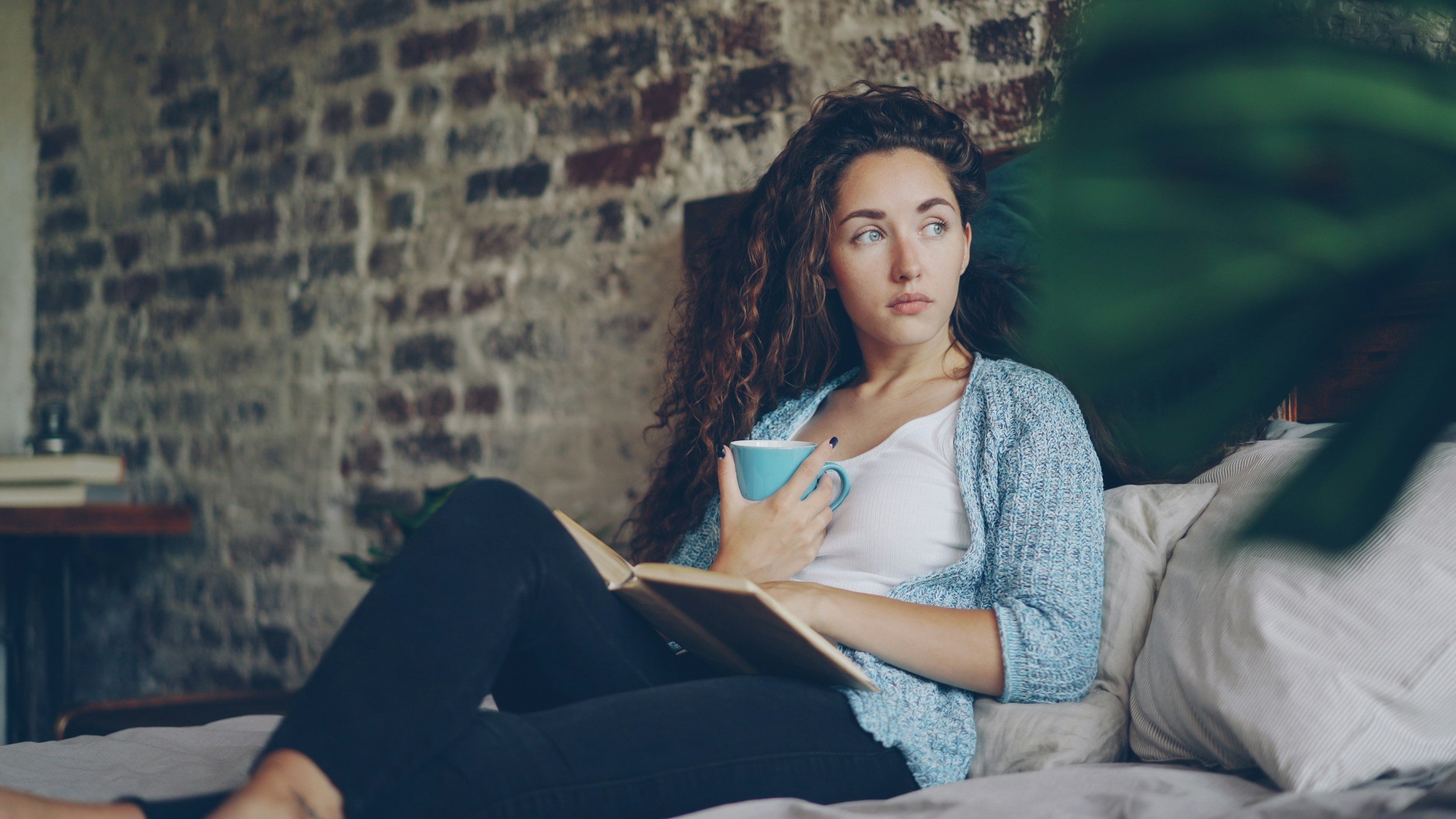 Women reading on bed her comfort zone