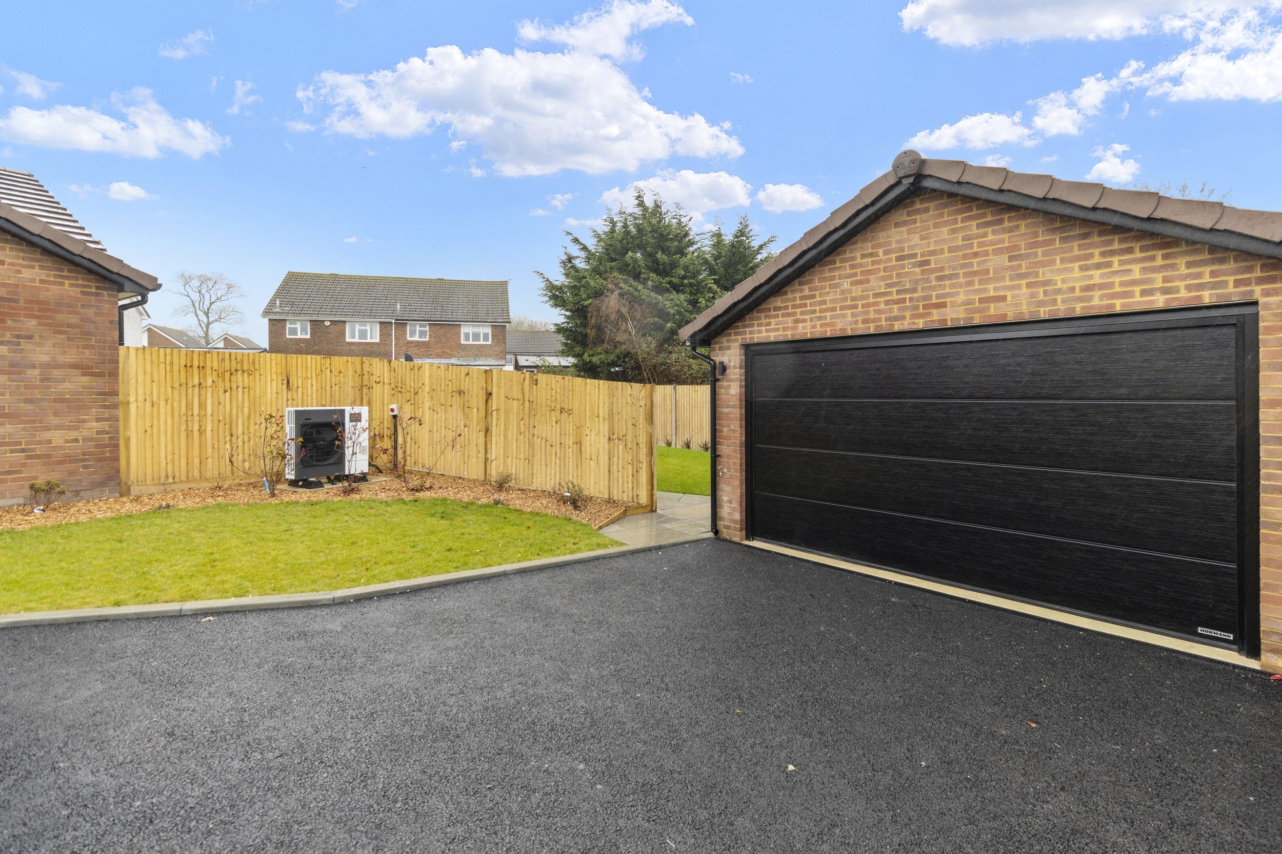 Residential driveway with a garage and lawn
