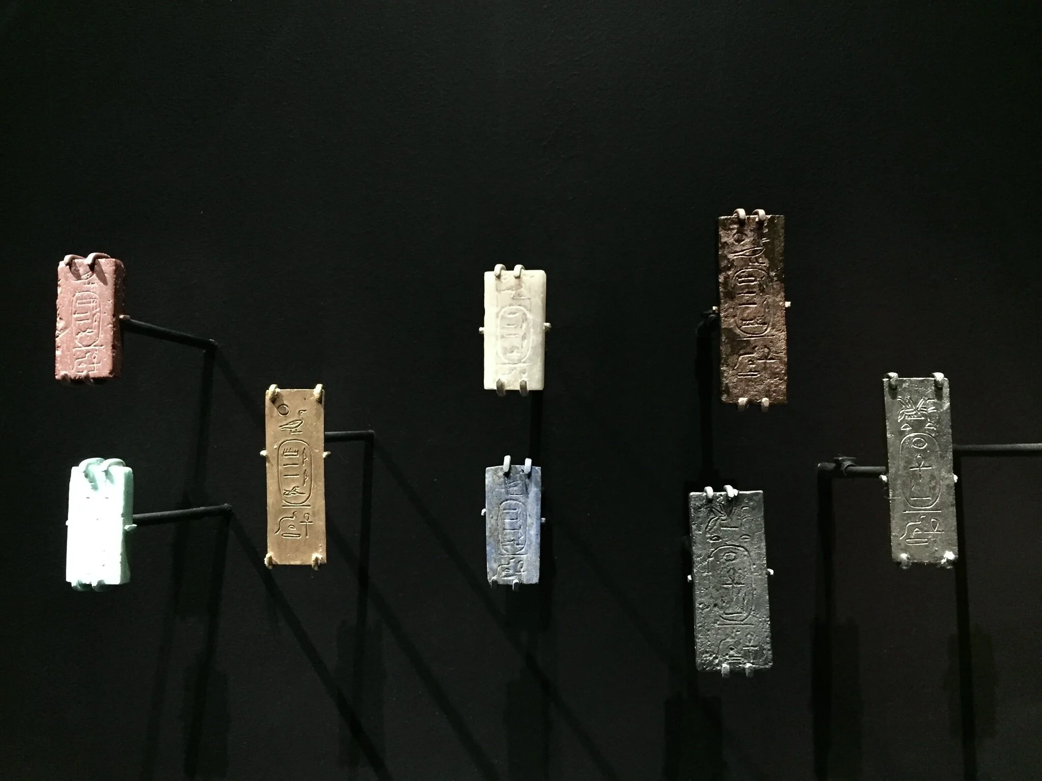 Foundation deposits included things like pottery, inscribed bricks, plaques, model tools, beads and other offerings. The plaques pictured above were displayed at the Museum of Fine Arts Boston. Photo by Elizabeth Minor.