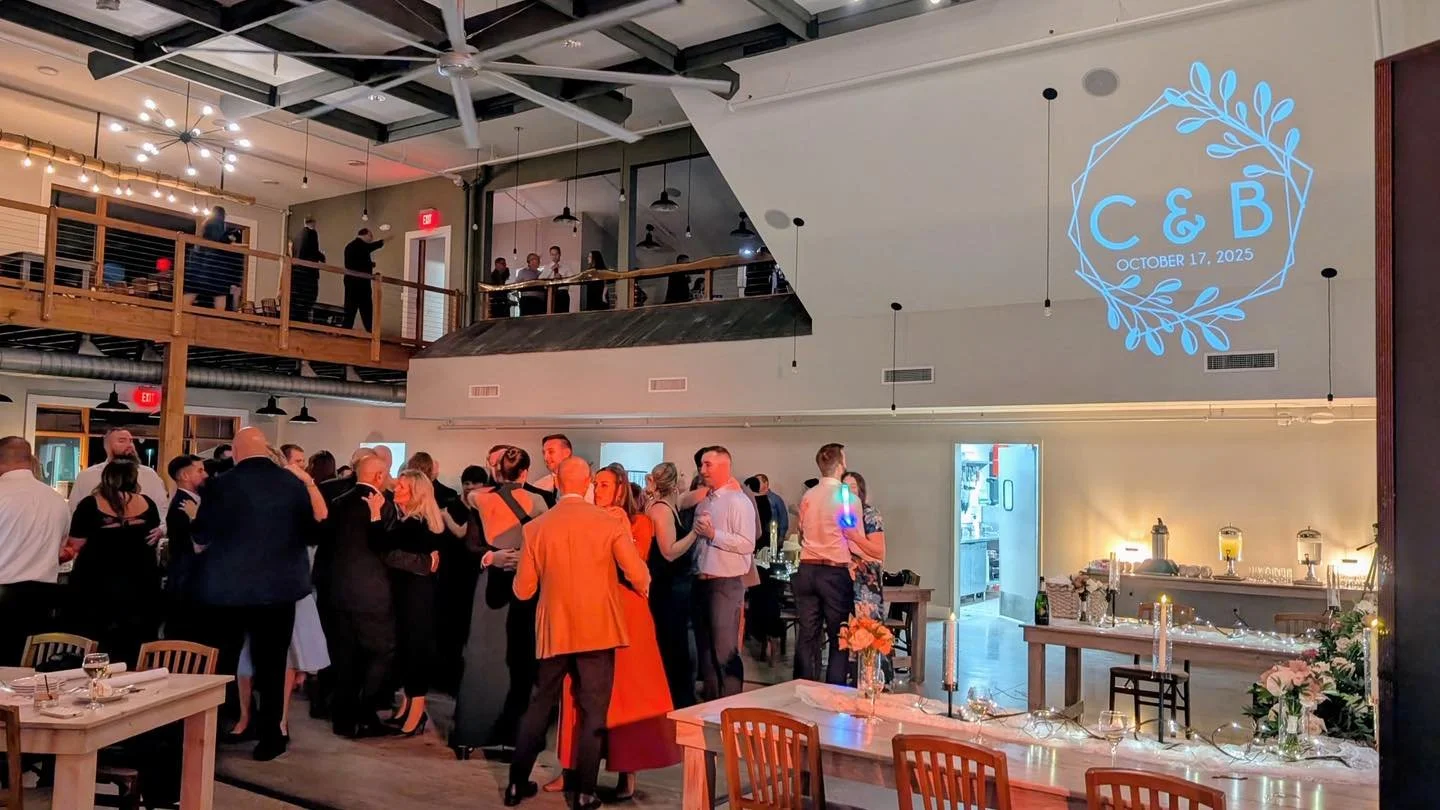 A custom monogram lights up the ceiling at The Lake House Venue in Ludington