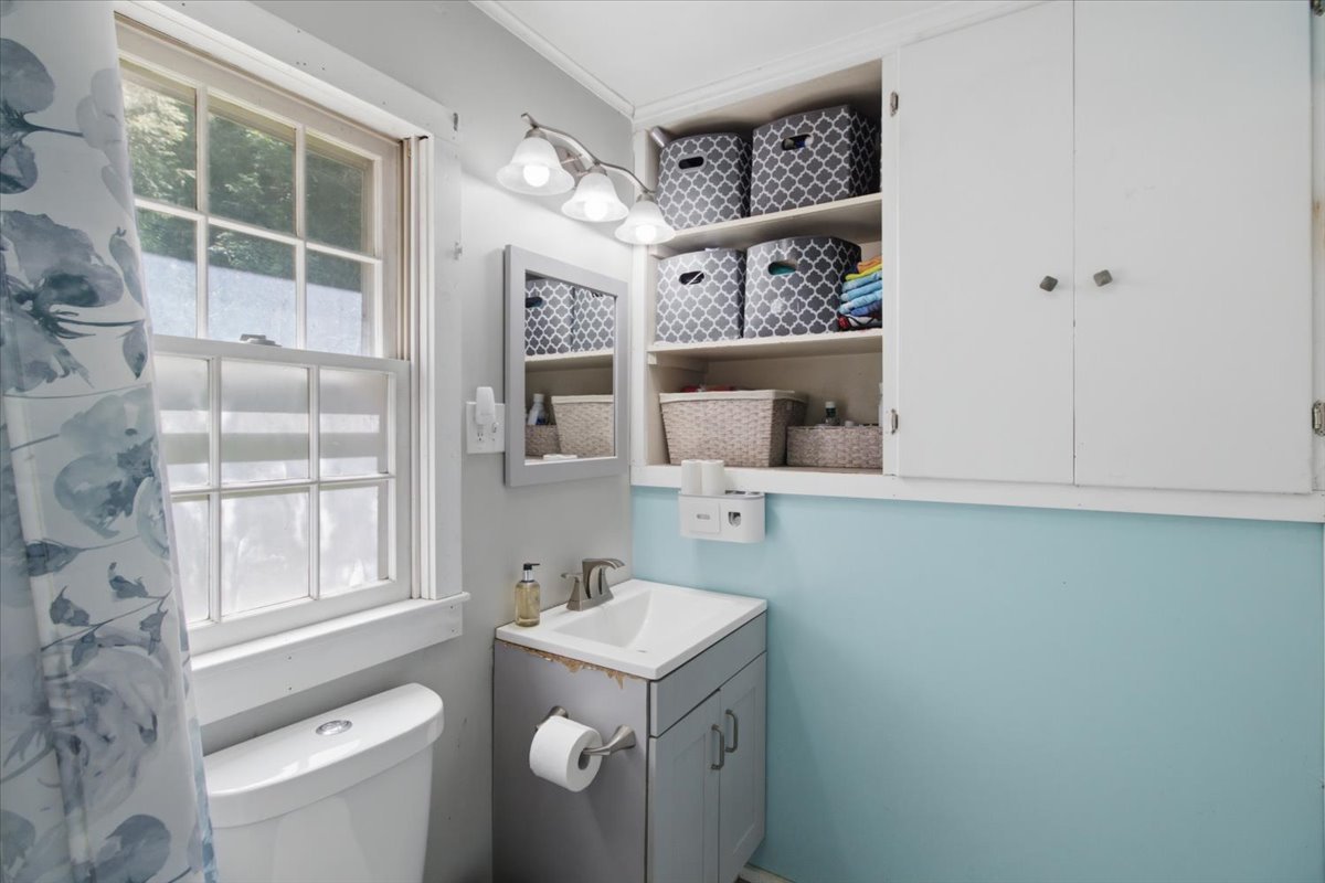 Bathroom with large window and built-in storage.