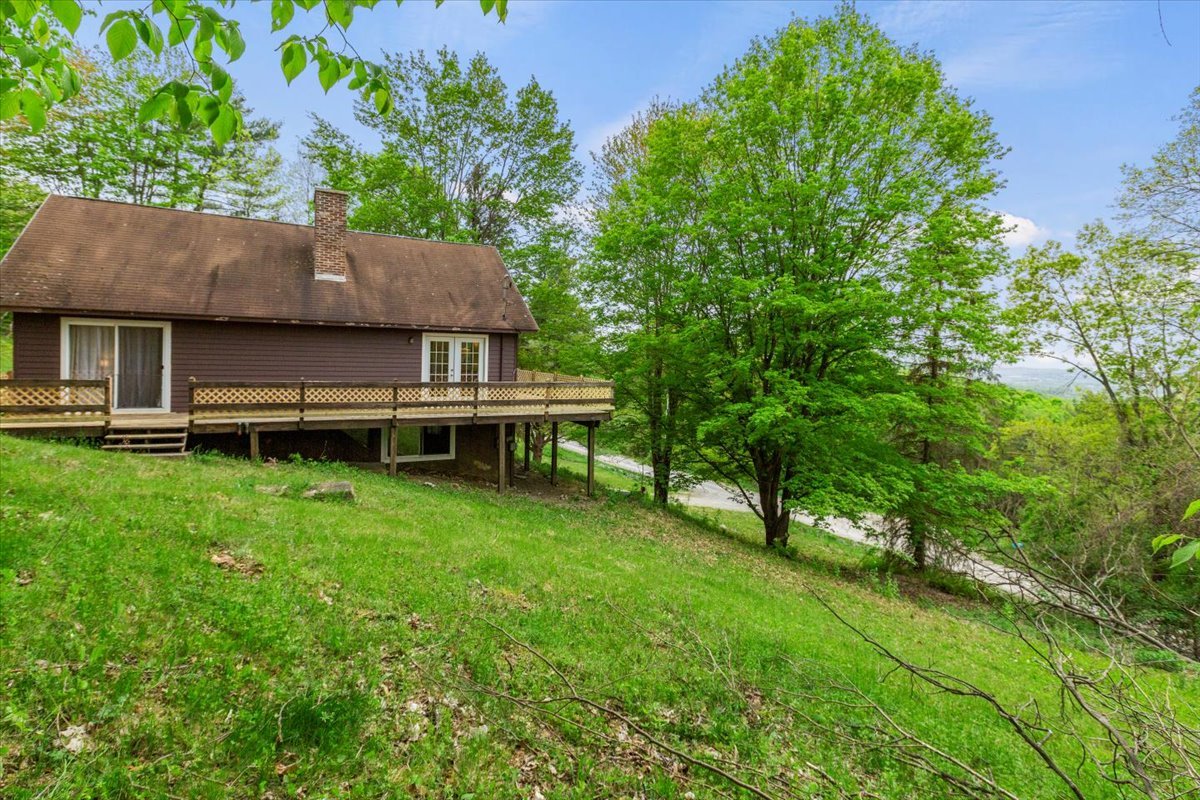 View of house with wraparound deck.
