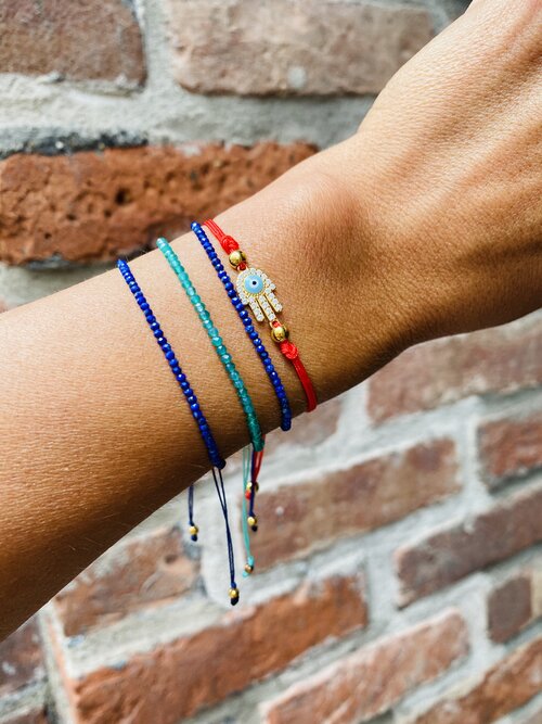 Atelier All Day Signature Collection Evil Eye Red String Bracelet, $29To shop our deep blue Sapphire String Bracelet for $33, click here, or for our teal version for $33, click here