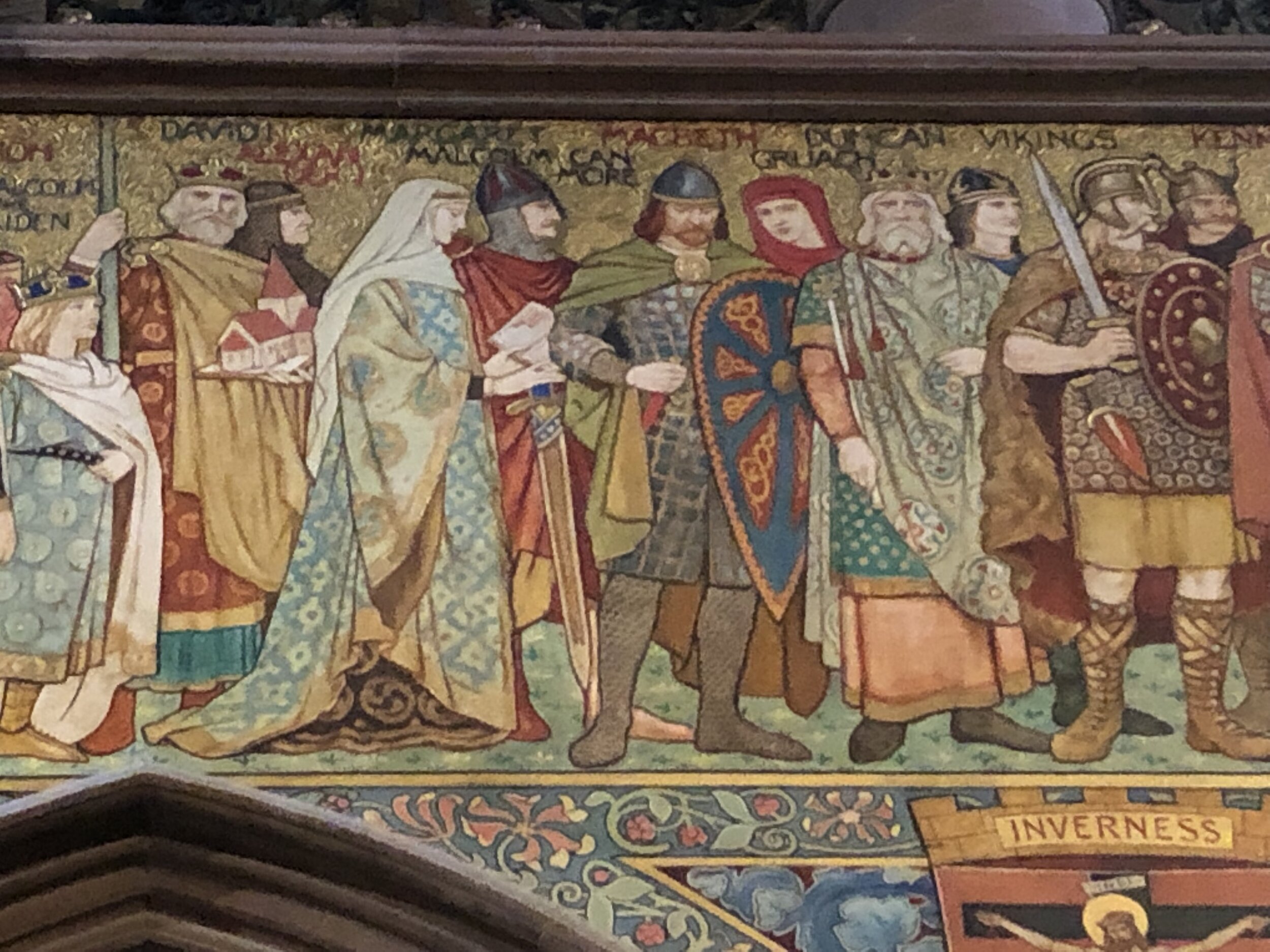 Macbeth, King of Scotland (with the shield) standing among the figures of history in the Great Hall