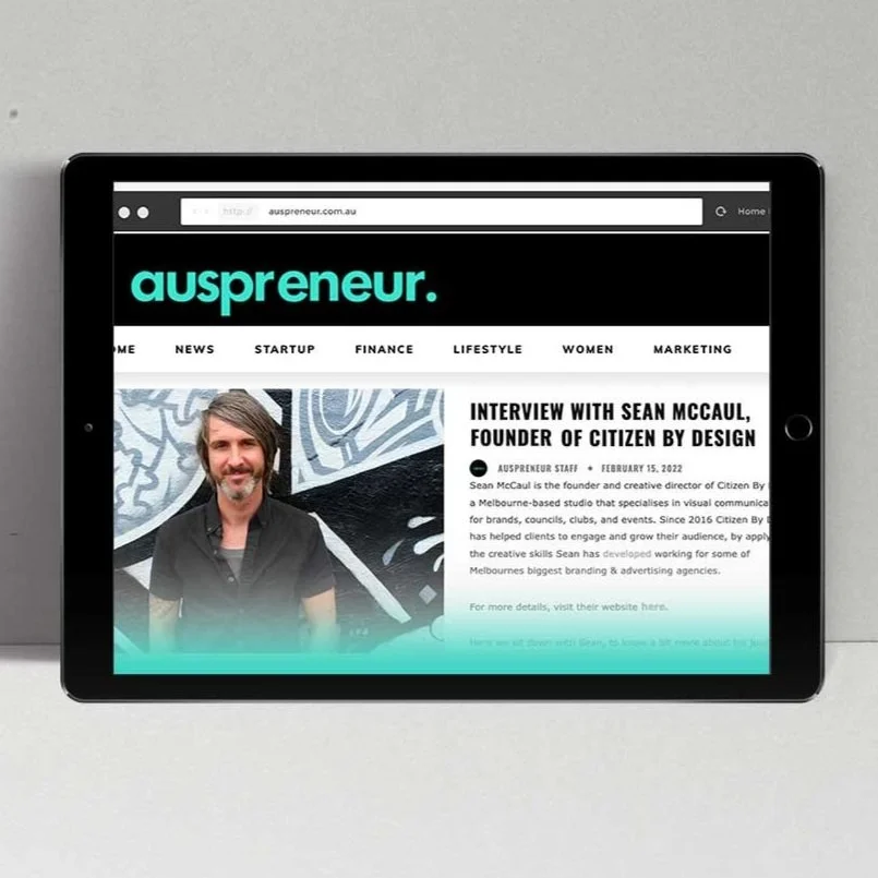 Tablet displaying a webpage of auspreneur with an interview article featuring Sean McCaul, founder of Citizen By Design, on a gray background.