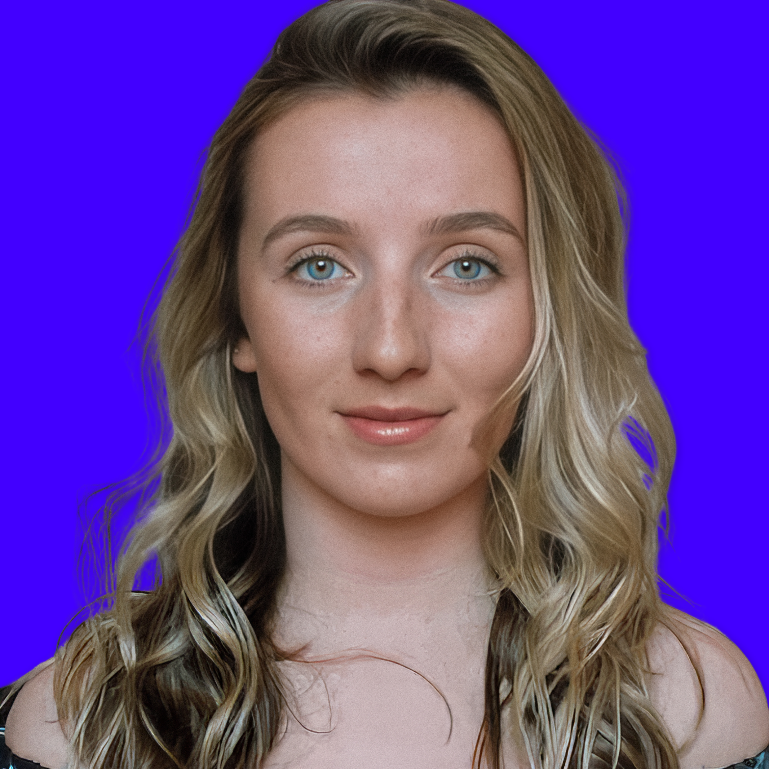 Close-up of a young woman with wavy blonde hair and blue eyes, smiling softly, against a solid blue background.