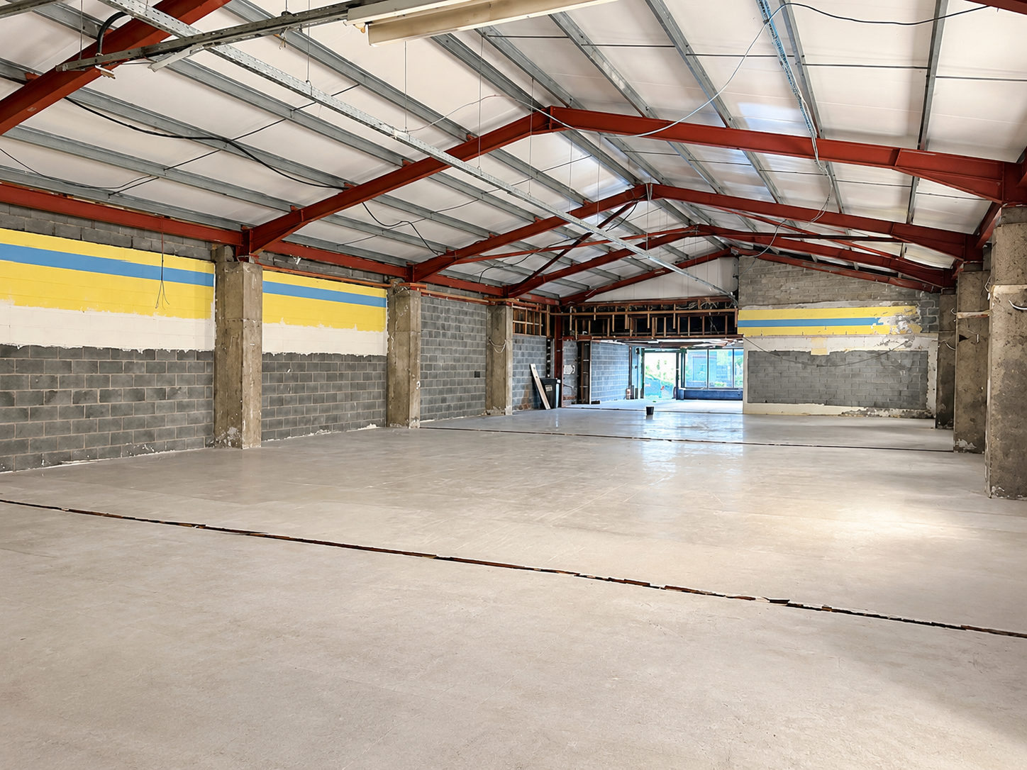 Empty Industrial Warehouse Interior.png