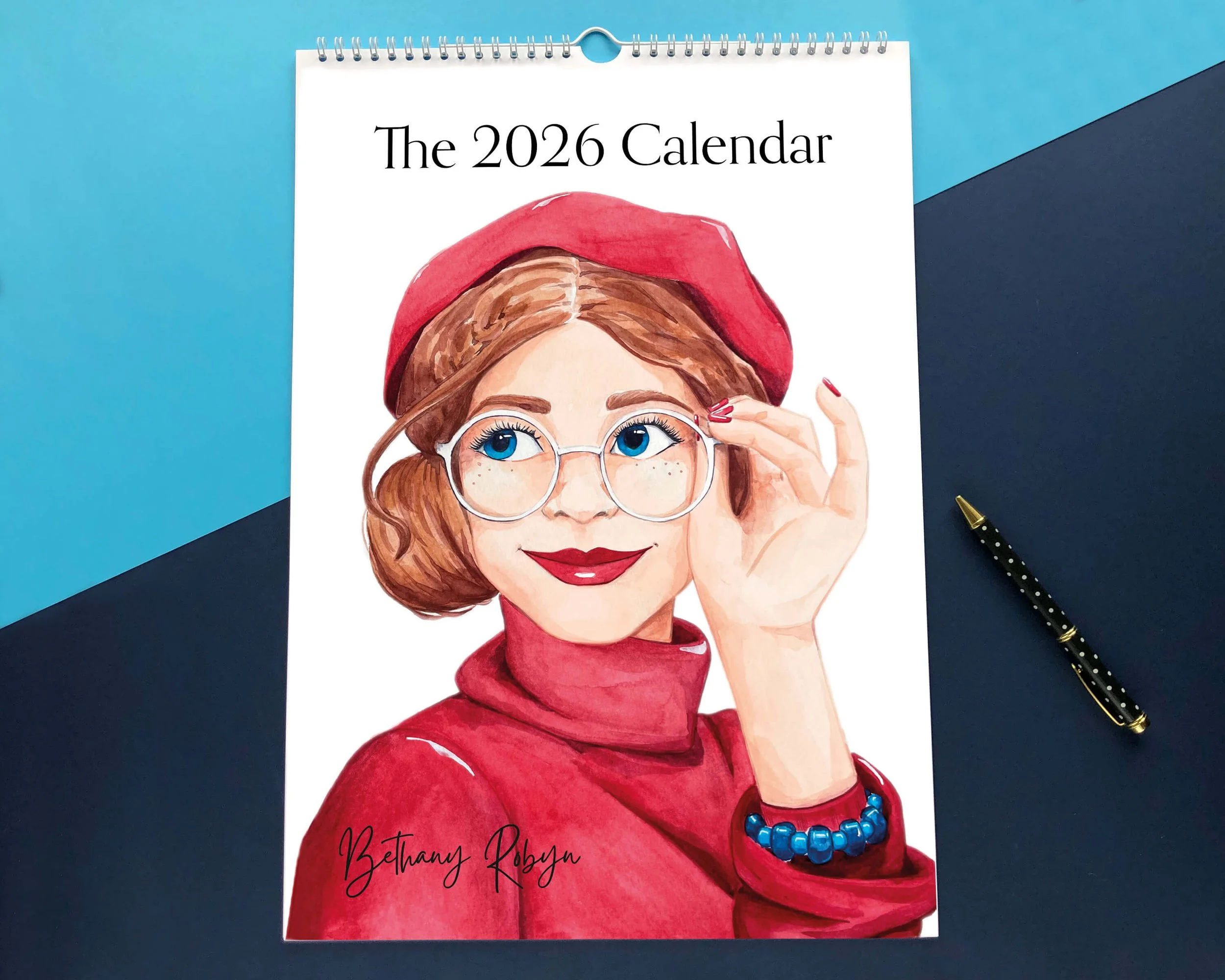 2026 art calendar illustrated front cover with cheeky brunette wearing red beret and red roll neck