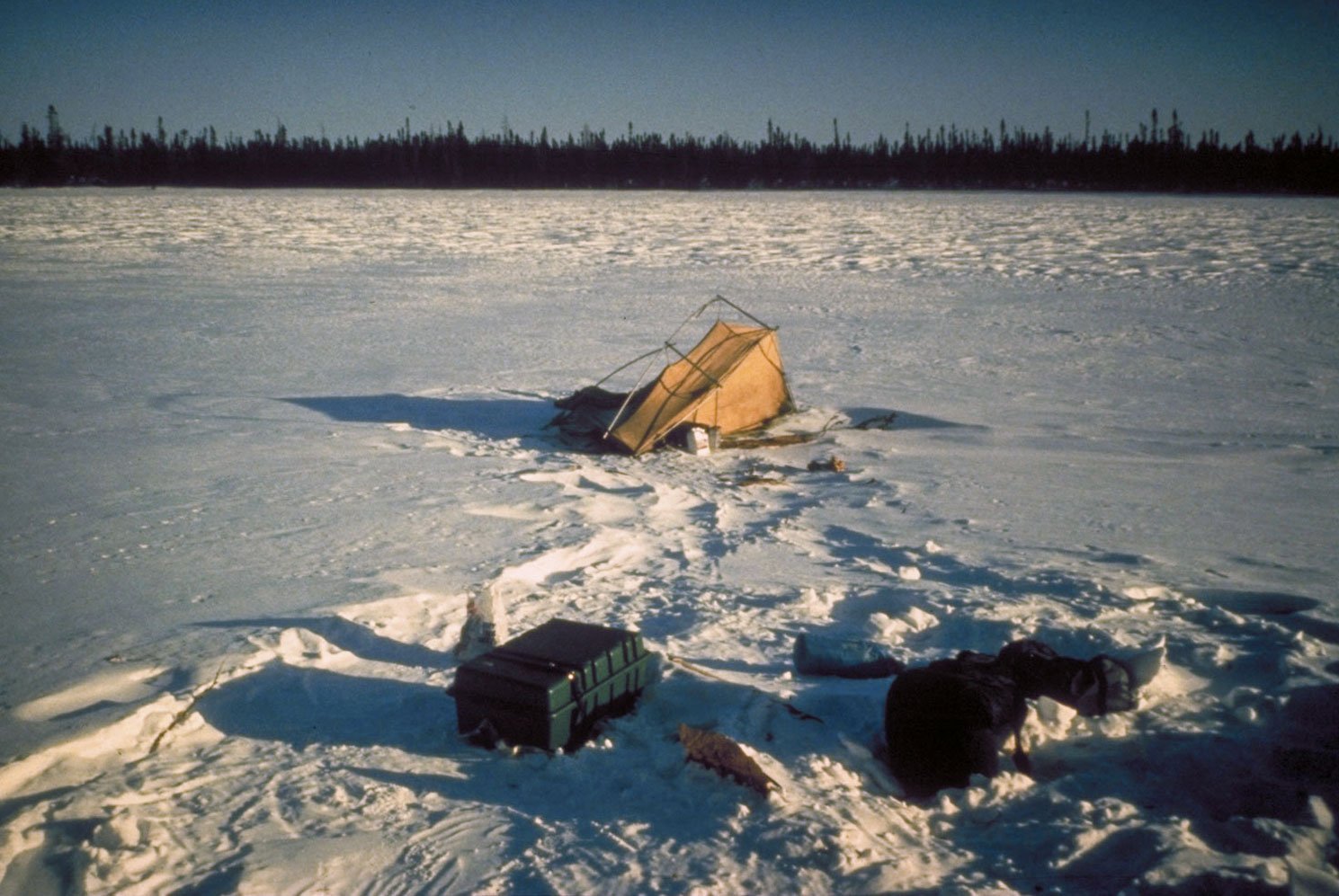 A tent fire prevented us from hydrating. Our only source of warmth was our frustration. Our tent was beaten by the wind being so exposed on the frozen lake. (image 15 of 22)