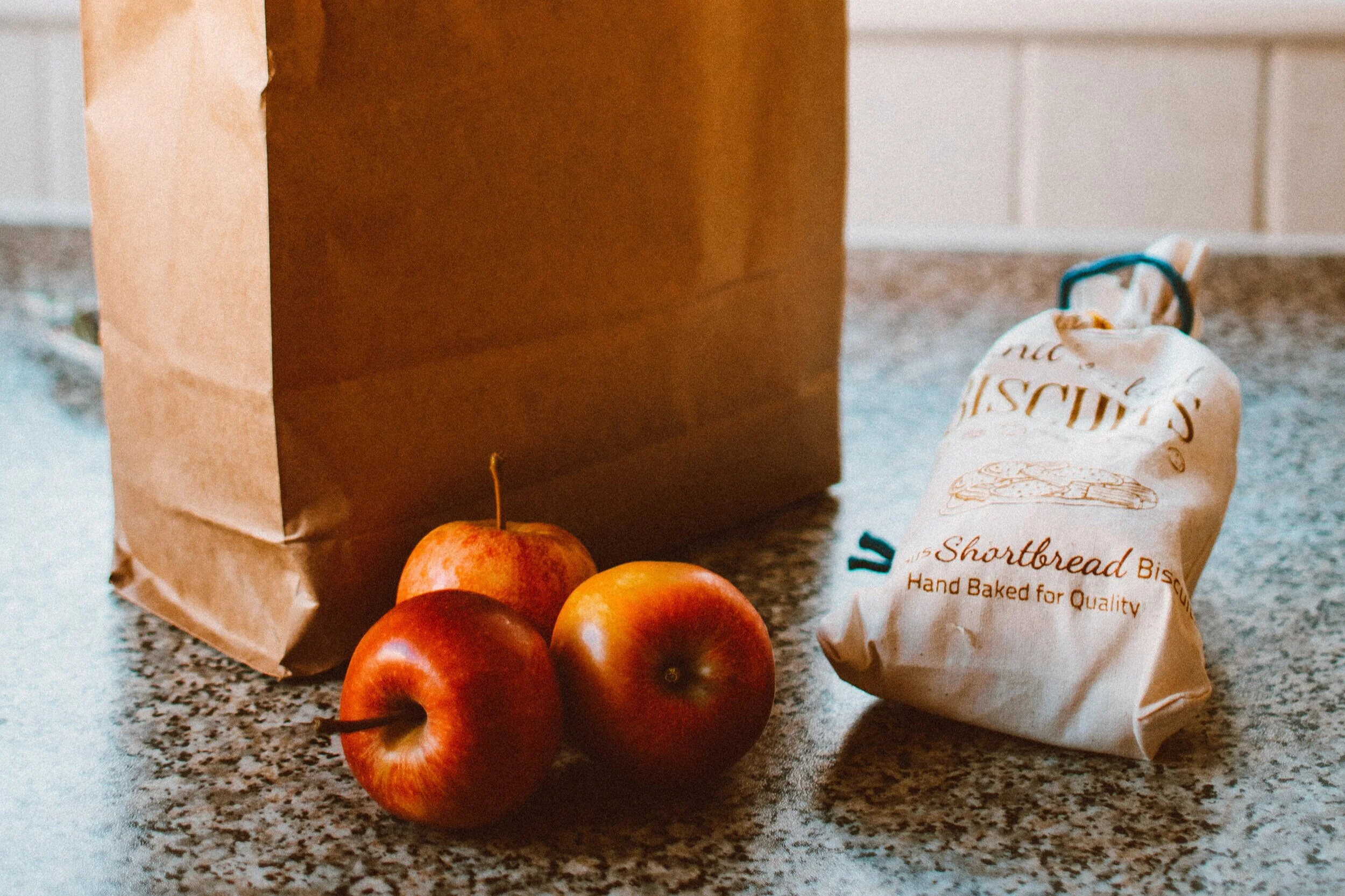 several-apples-beside-bread-pack-and-brown-paper-bag-1992912.jpg