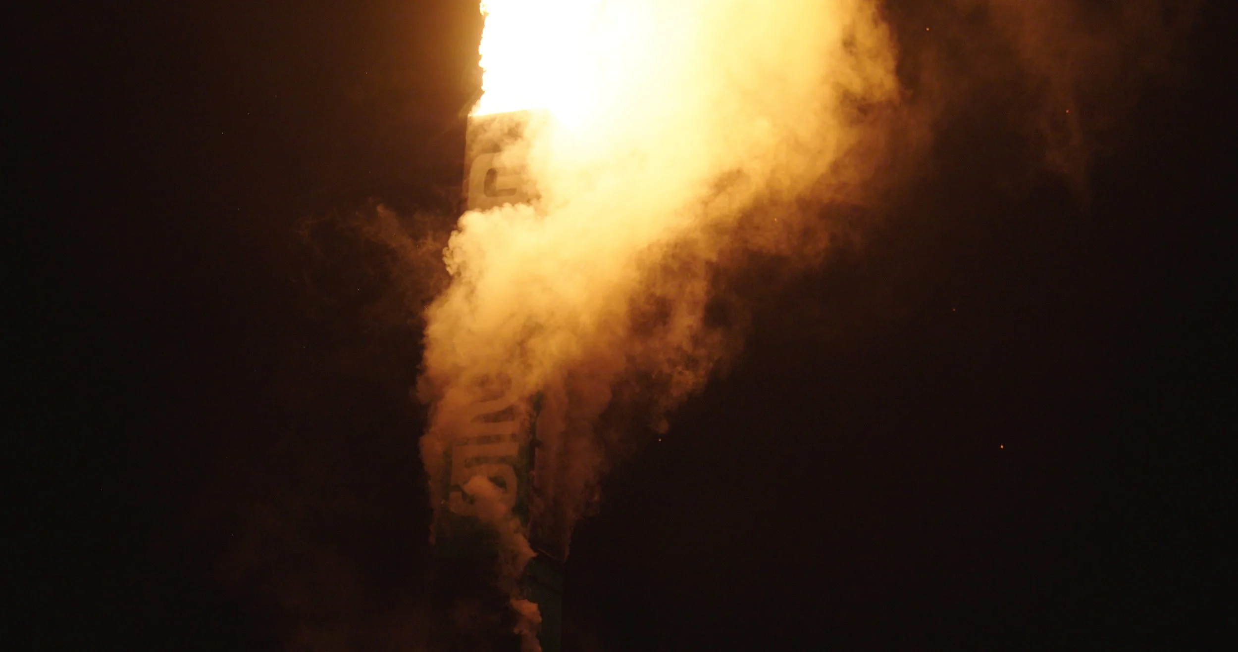 Bright flare lighting up the desert at night during the adventure trip.