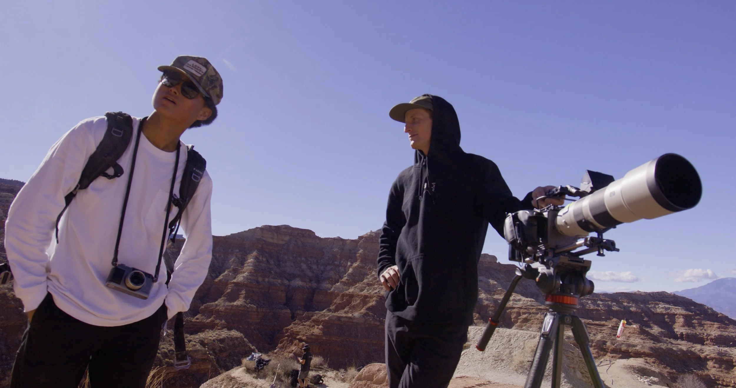 Live event video production capturing a professional camera operator filming a large-scale event with cinema camera and long lens