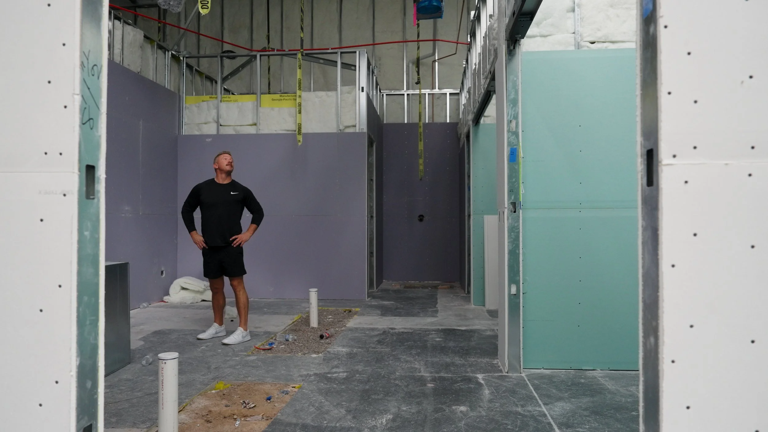 Interior construction progress of Hive Fit Club showing unfinished gym hallways during the facility build-out in Scottsdale Arizona.