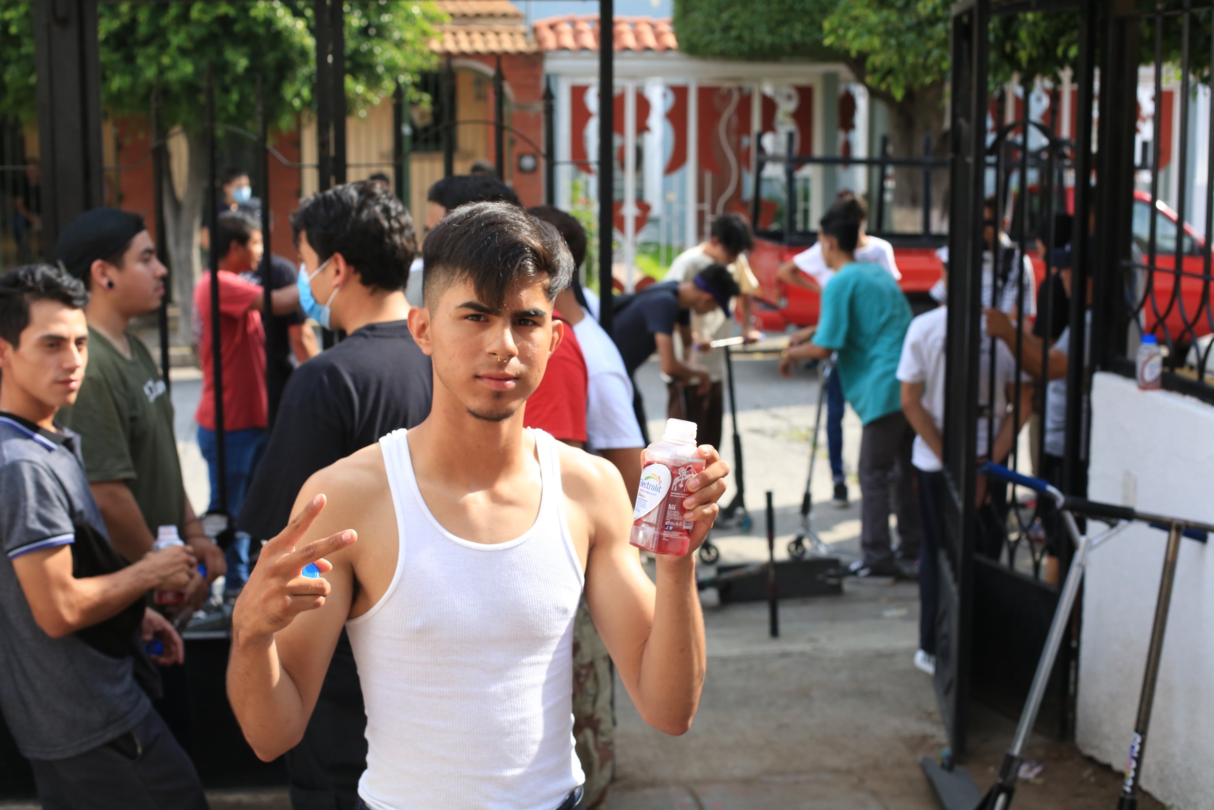 Documentary footage of a scooter rider preparing with friends before filming begins at the TV Gram event in Mexico