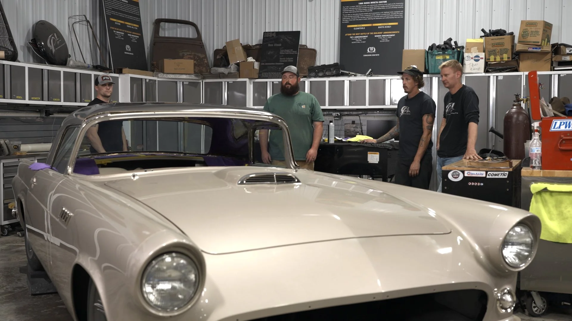 CAL Auto Creations team reviewing a custom-built classic car inside their Bennington, Nebraska workshop during Barrett-Jackson Cup preparation.