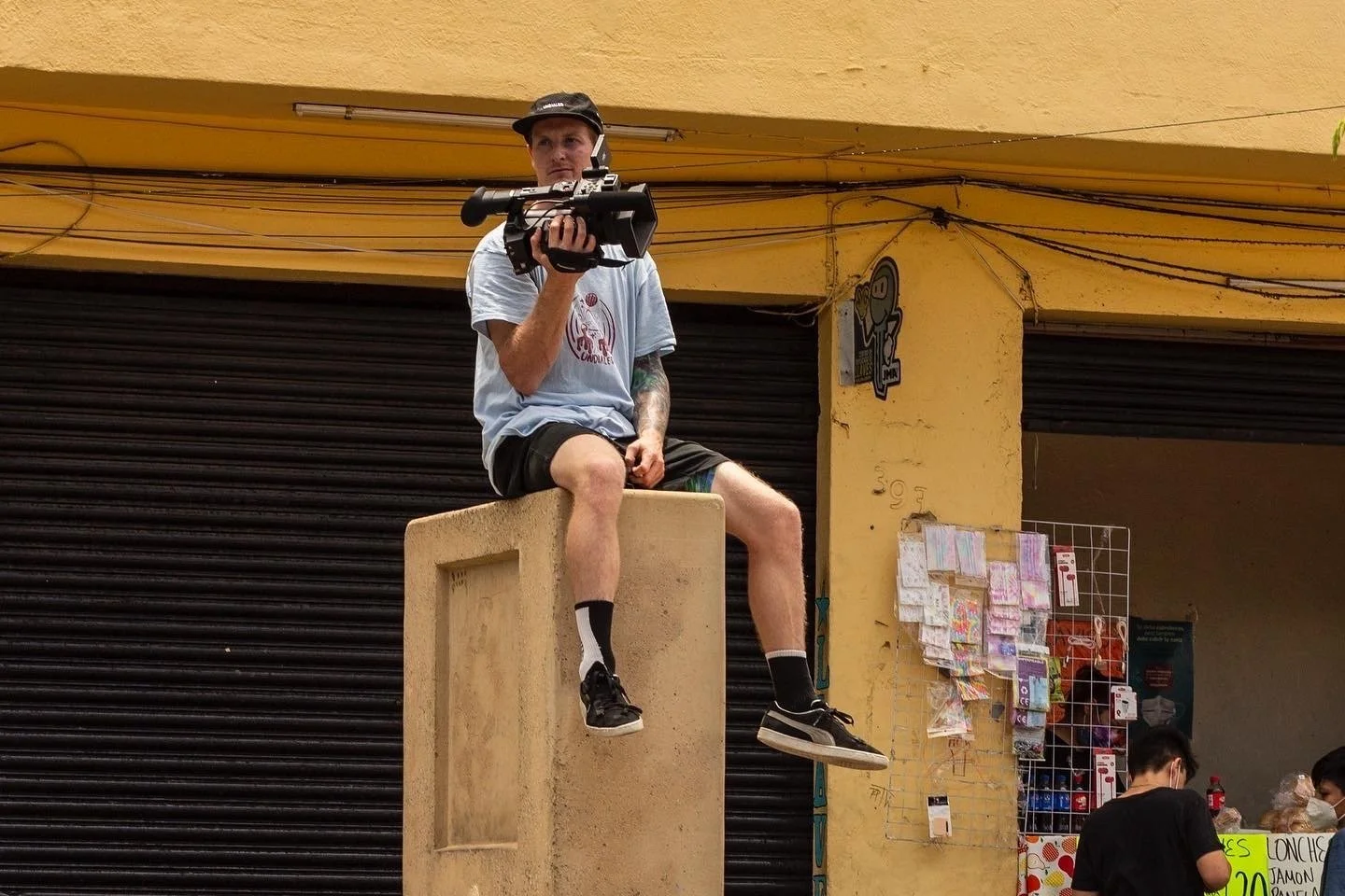 Behind-the-scenes documentary footage of Clayton Lindley filming scooter riders landing tricks during TV Gram