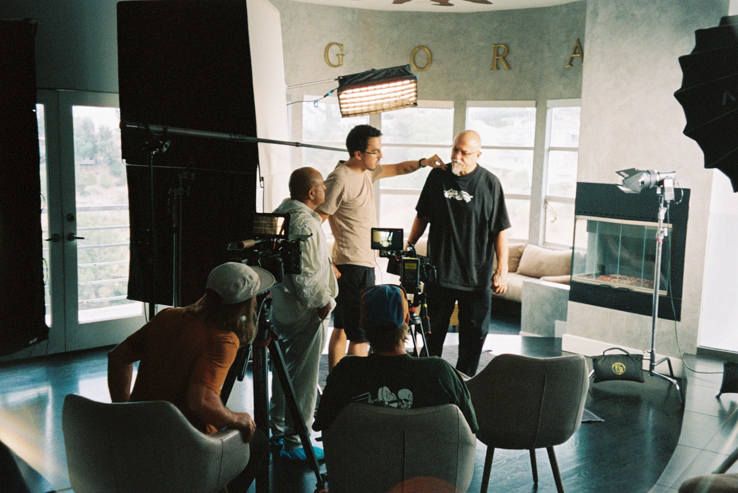 Behind-the-scenes documentary interview setup with crew filming interviews for the MC Magic documentary