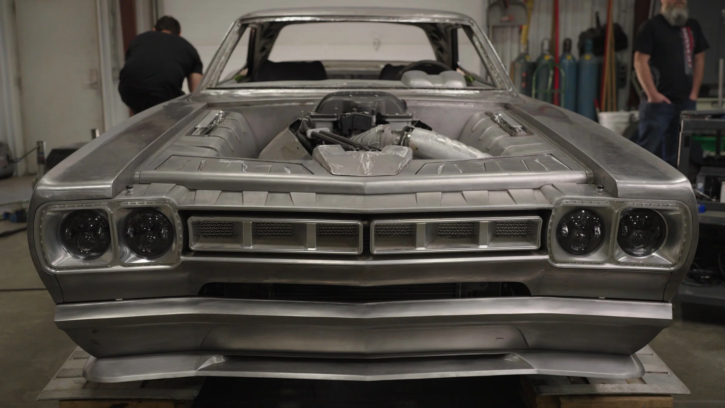 Front view of unfinished custom car build featured in the Barrett-Jackson Cup competition documentary series.