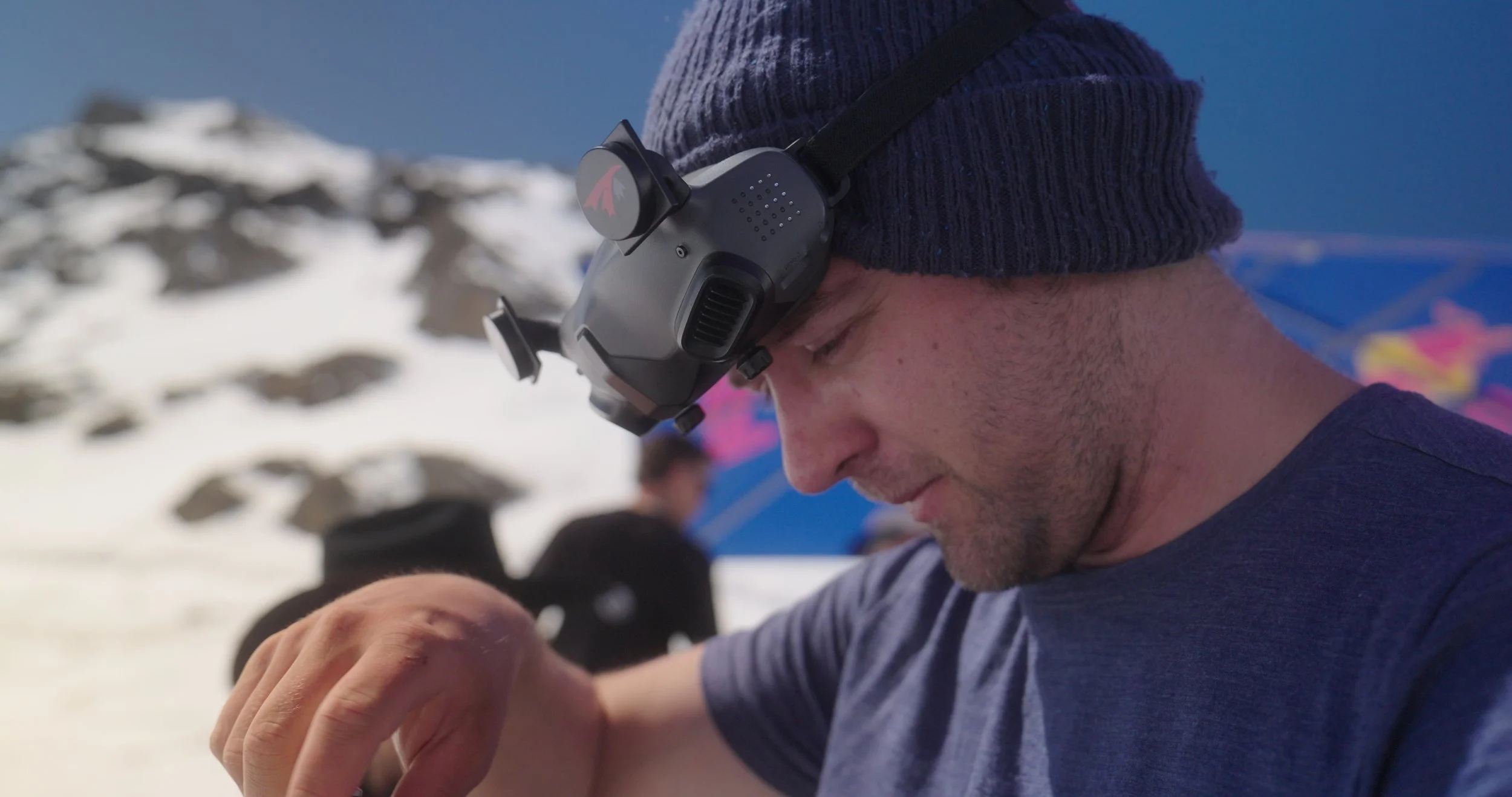 FPV Pilot adjusting drone before run at Swatch Nines, filmed for professional snowboard event production.