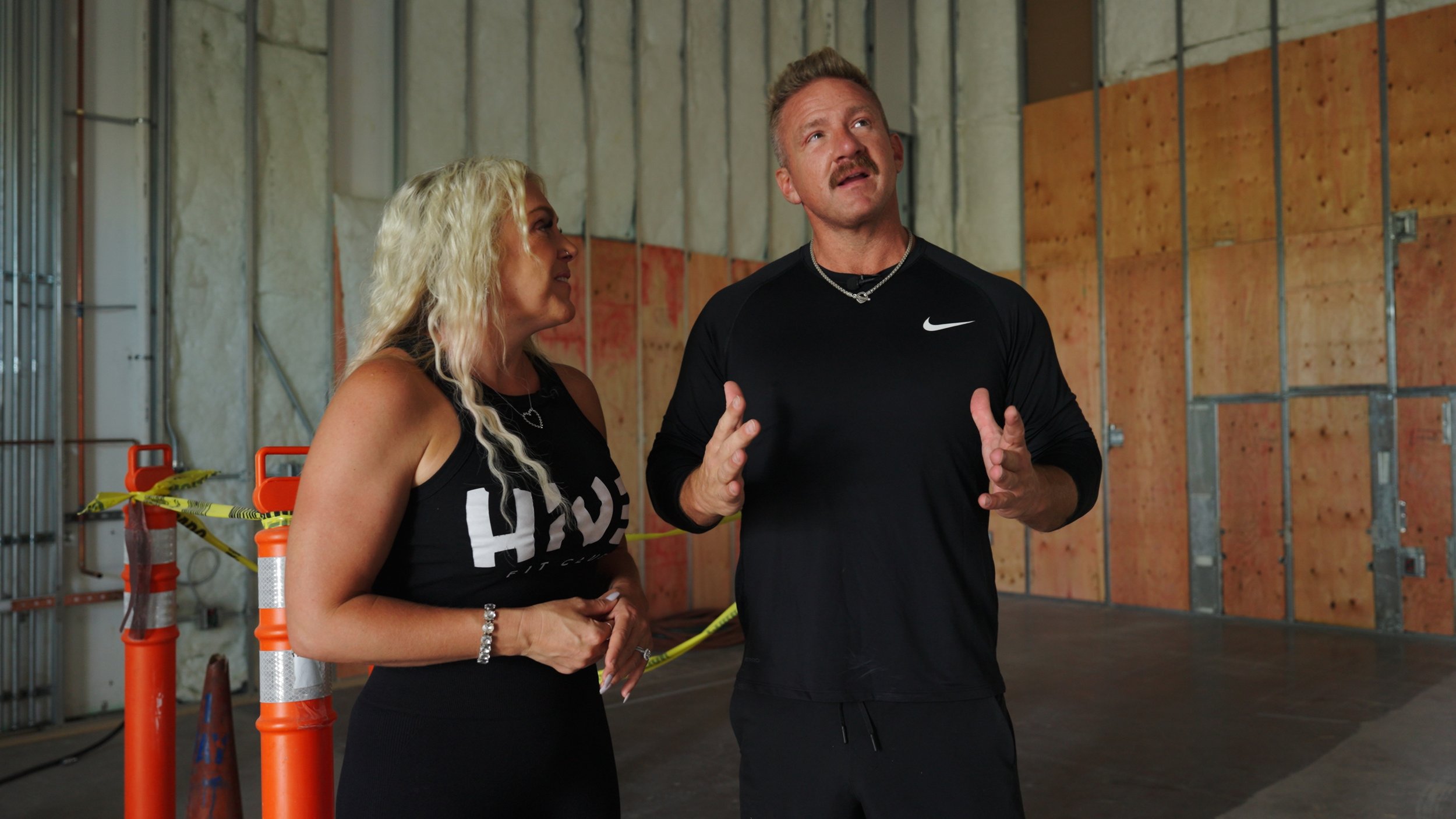 Hive Fit Club founders discussing the construction progress of the luxury fitness facility during documentary filming in Scottsdale Arizona.