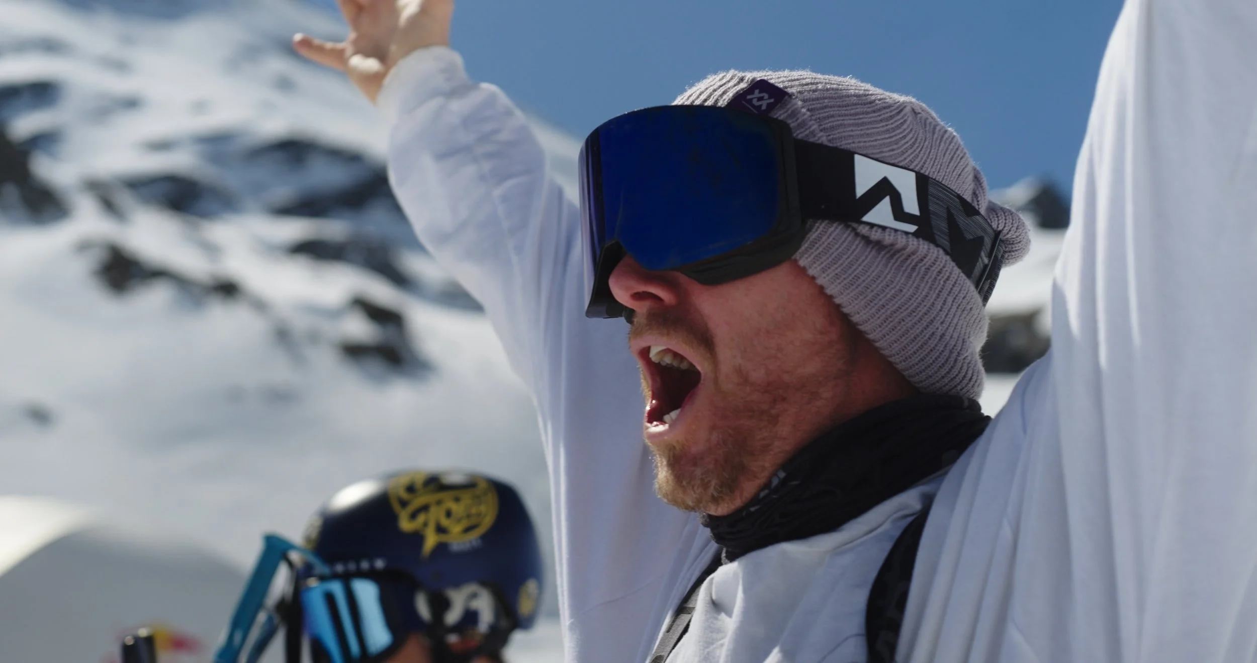 Professional snowboard athlete celebrating after landing a trick at Swatch Nines in Switzerland, captured for action sports documentary production.