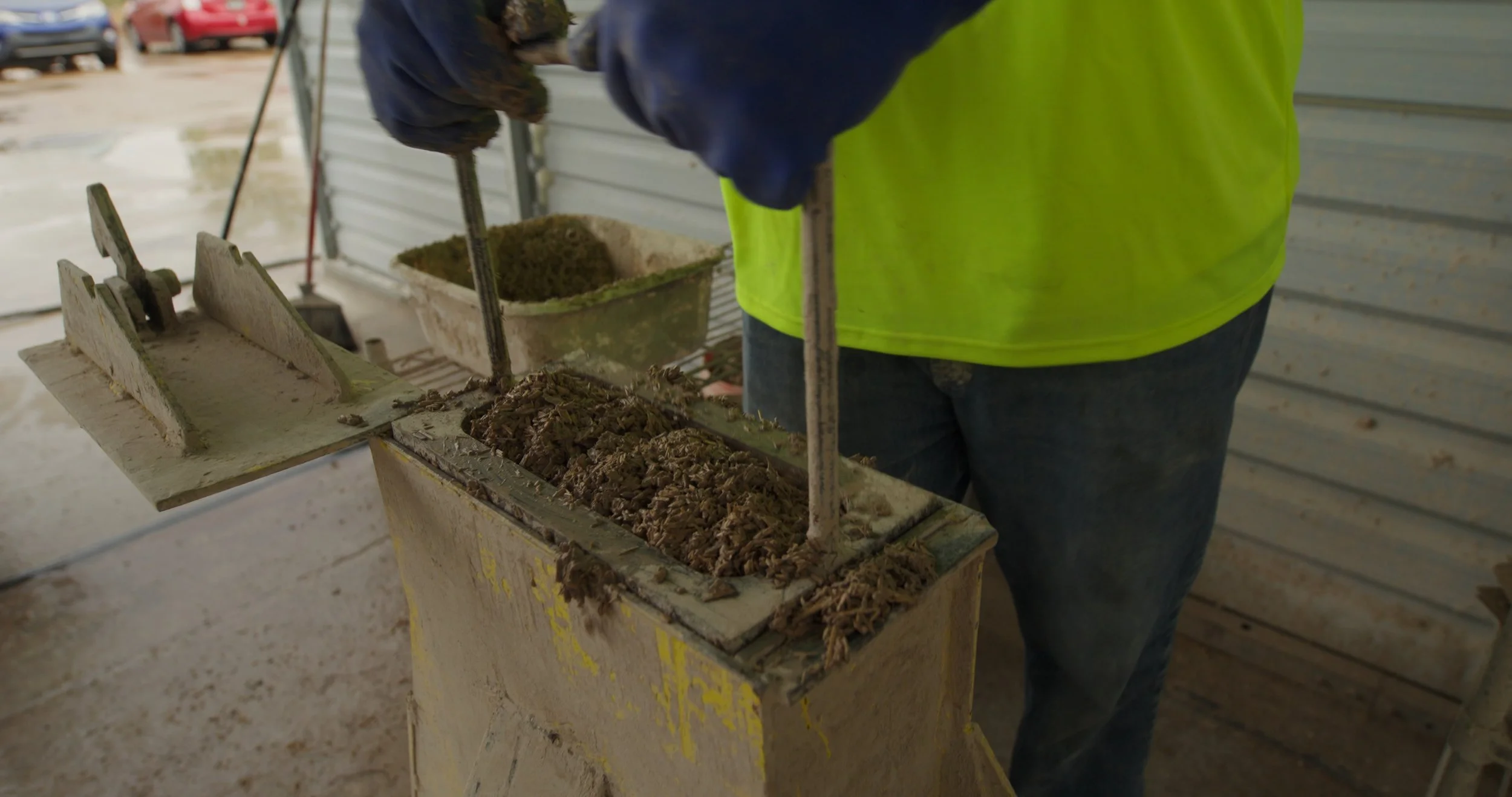 Documentary footage showing a hemp block being formed during sustainable building material production at Old Pueblo in Tucson Arizona