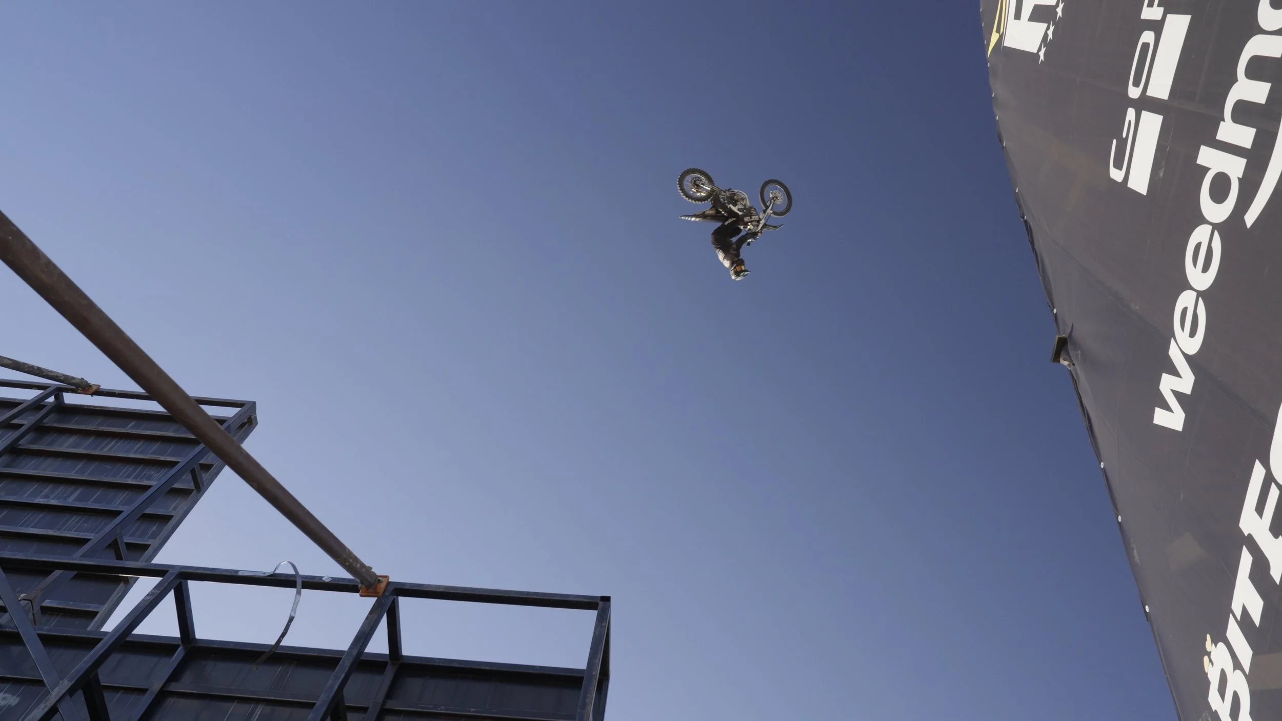 Motocross rider mid-air above the ramp during the Record Breakers world record attempt, filmed by Ragtown Media