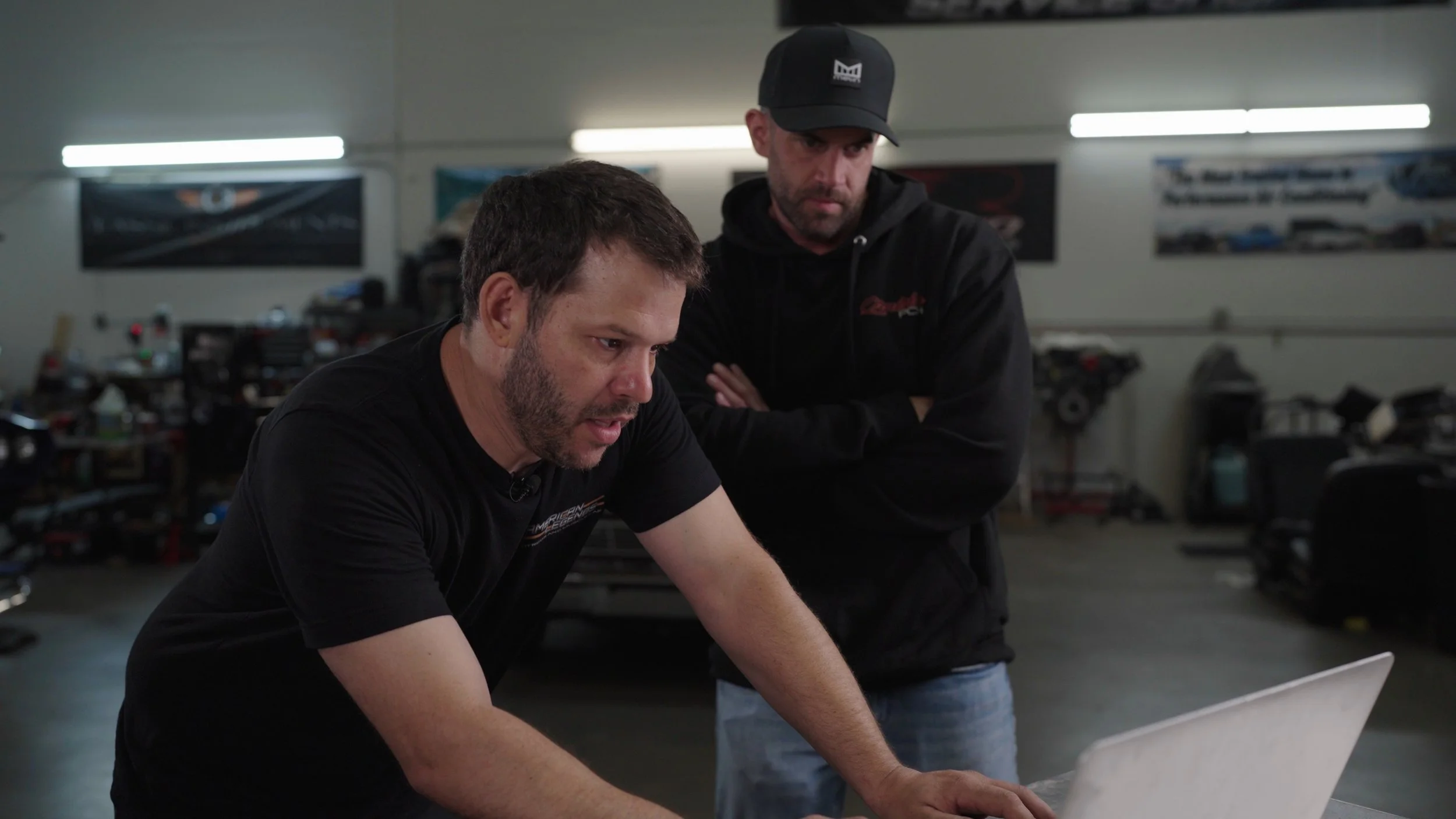 Classic muscle car on lift inside All American Hot Rods Phoenix workshop during Barrett-Jackson Cup competition preparation