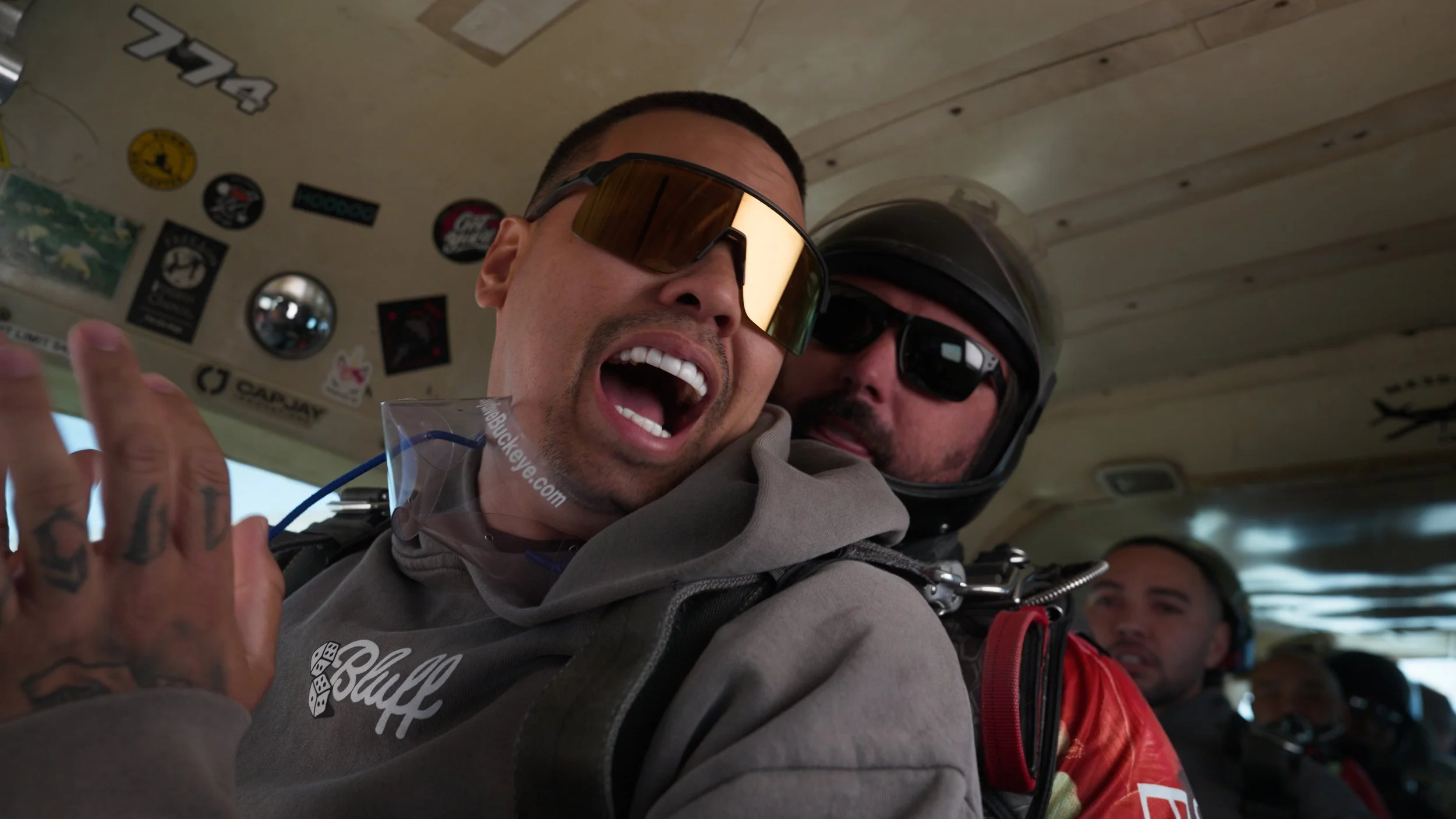 Skydiver holding phone during freefall for SpinQuest app commercial