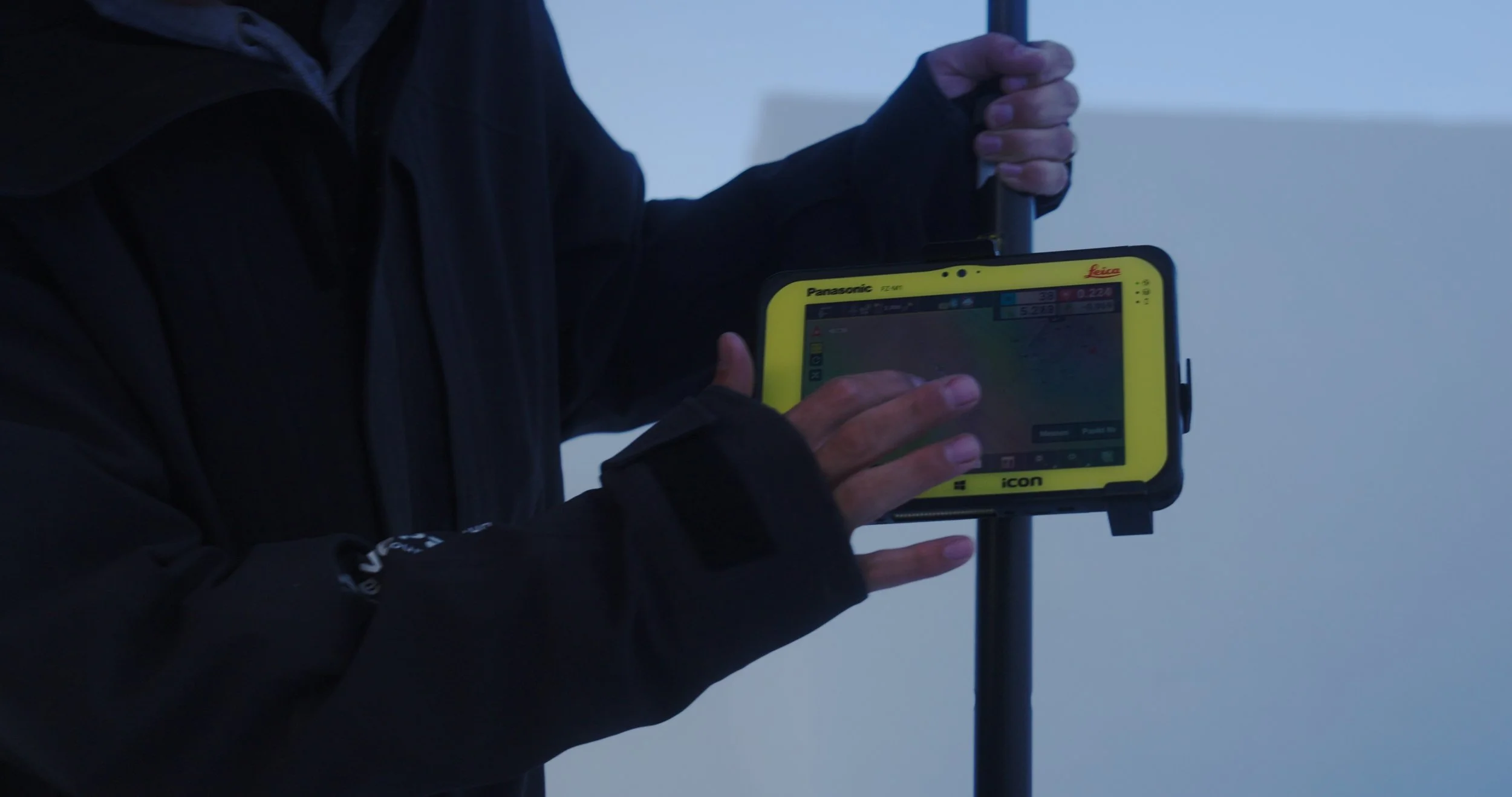 Engineering team measuring terrain data during Swatch Nines snowboard course build in Switzerland for action sports documentary production