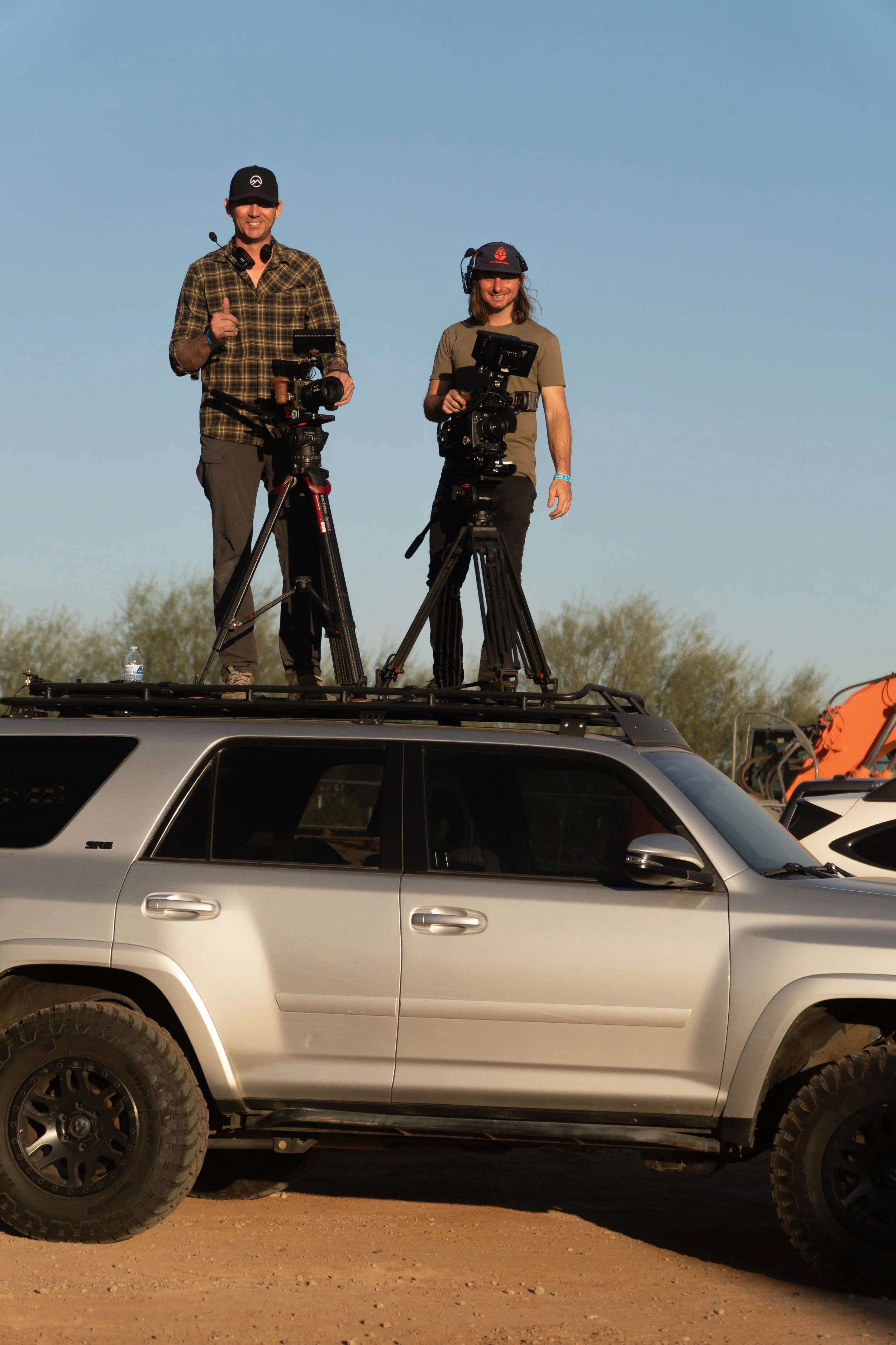 Two camera operators filming live extreme sports event in Arizona desert