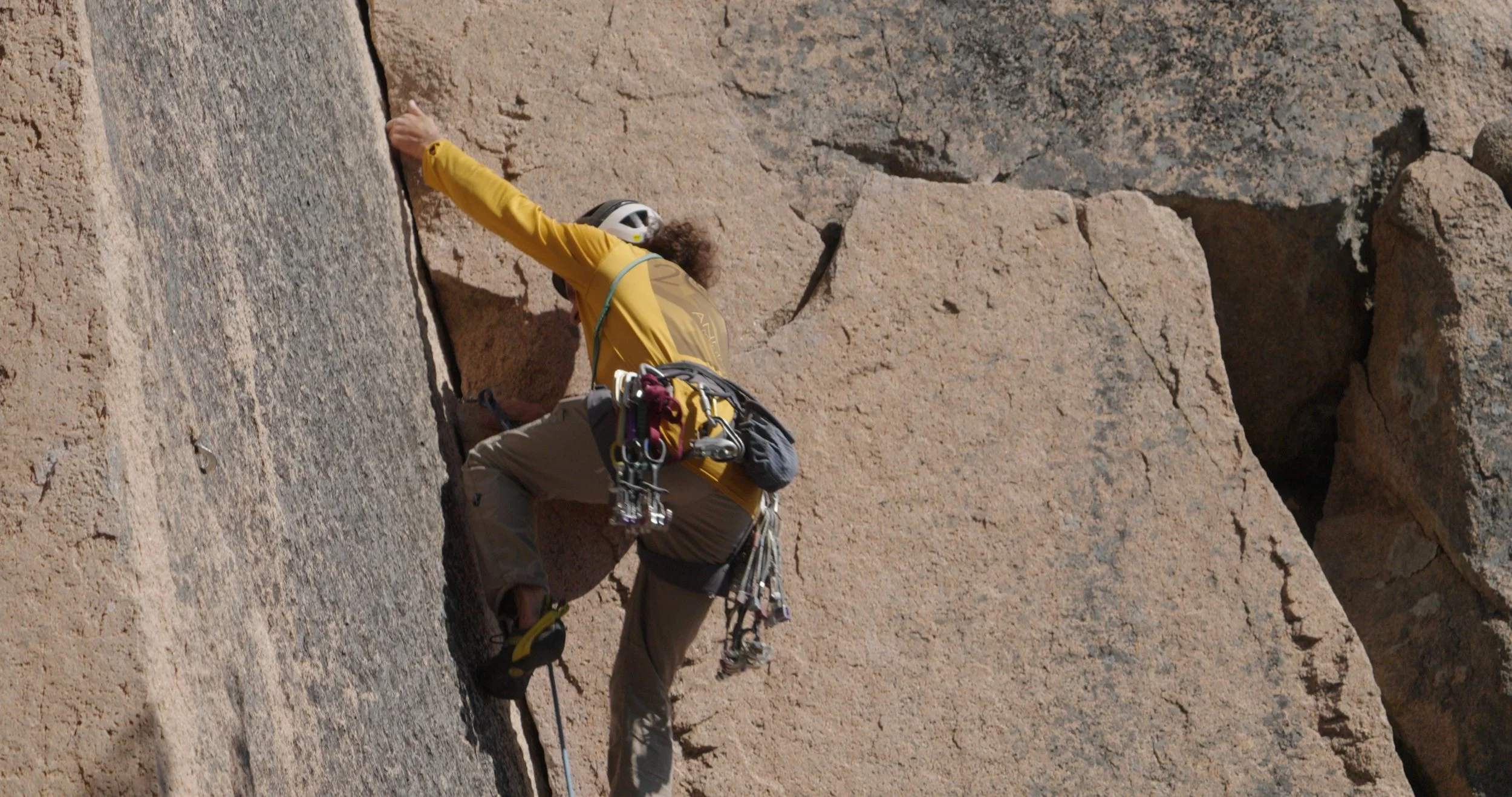 Climber Andrea on a cliff face in The Next Move rock climbing documentary by Ragtown Media