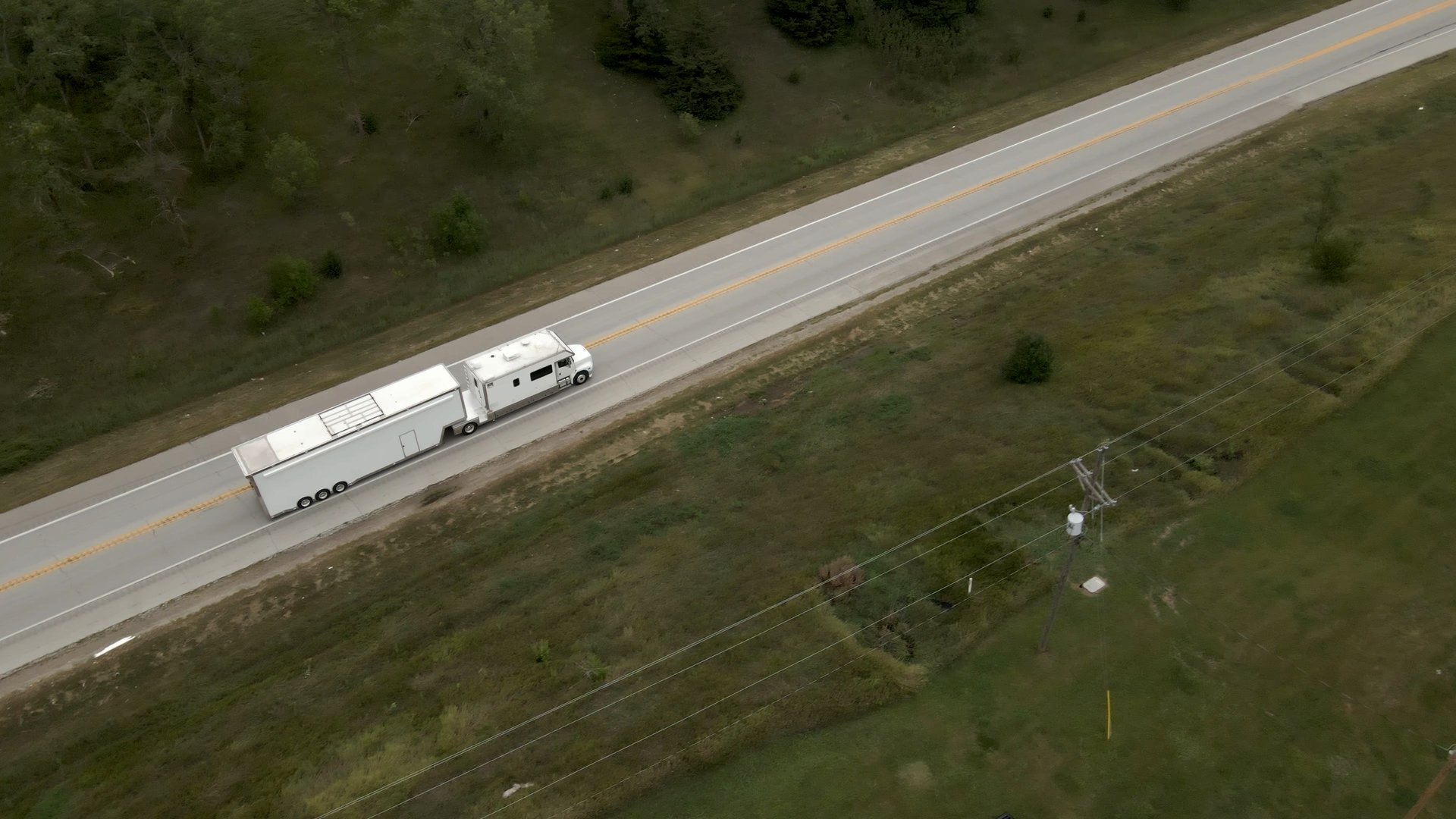 Aerial drone shot of a custom car hauler traveling to the Barrett-Jackson Cup in Scottsdale, Arizona, filmed for a behind-the-scenes automotive documentary series.