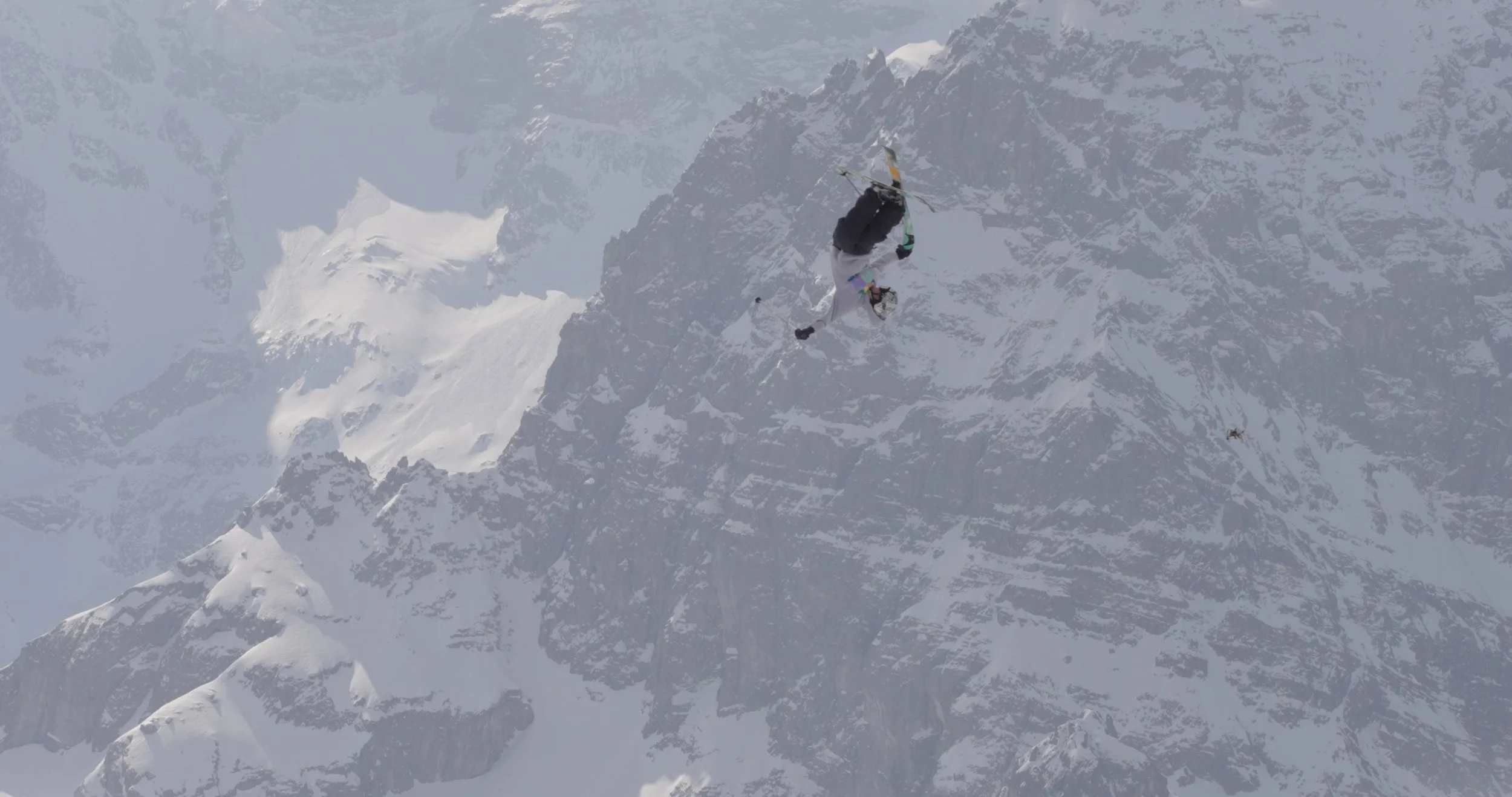 long lens cinematic shot of large sculpted snow terrain during Swatch Nines Switzerland, showcasing scale for snowboard and freeski event production.