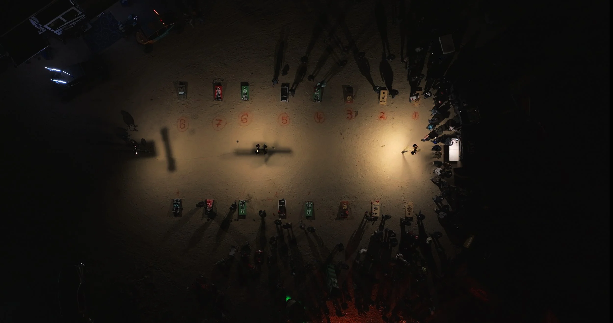Aerial view of a nighttime desert gathering during the guys trip documentary.