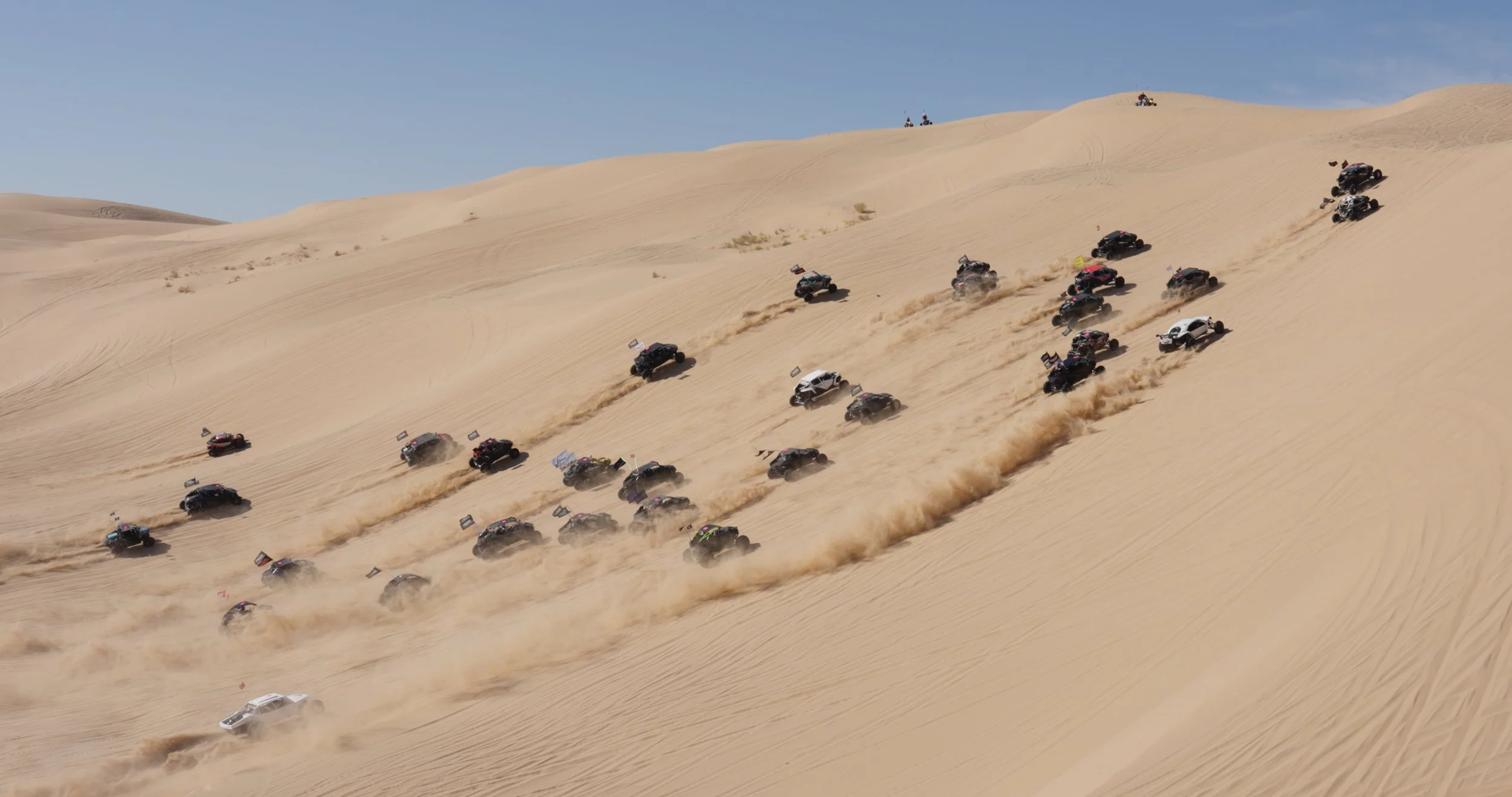 Group of off-road vehicles driving in formation across large desert sand dunes during a guys trip adventure.