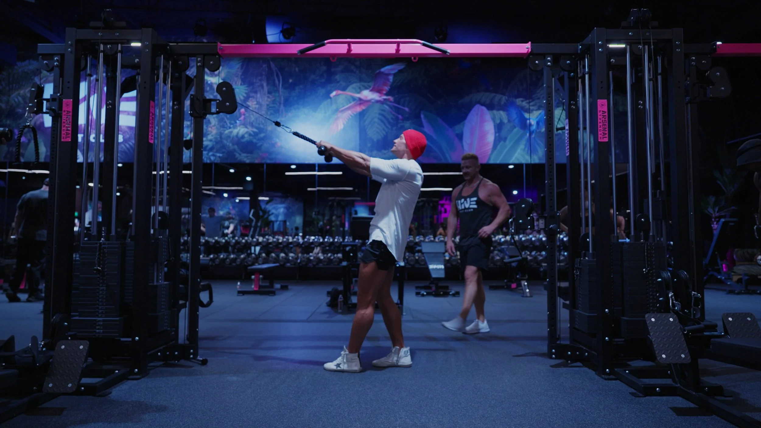 Athletes training on strength equipment at Hive Fit Club during a group workout session.