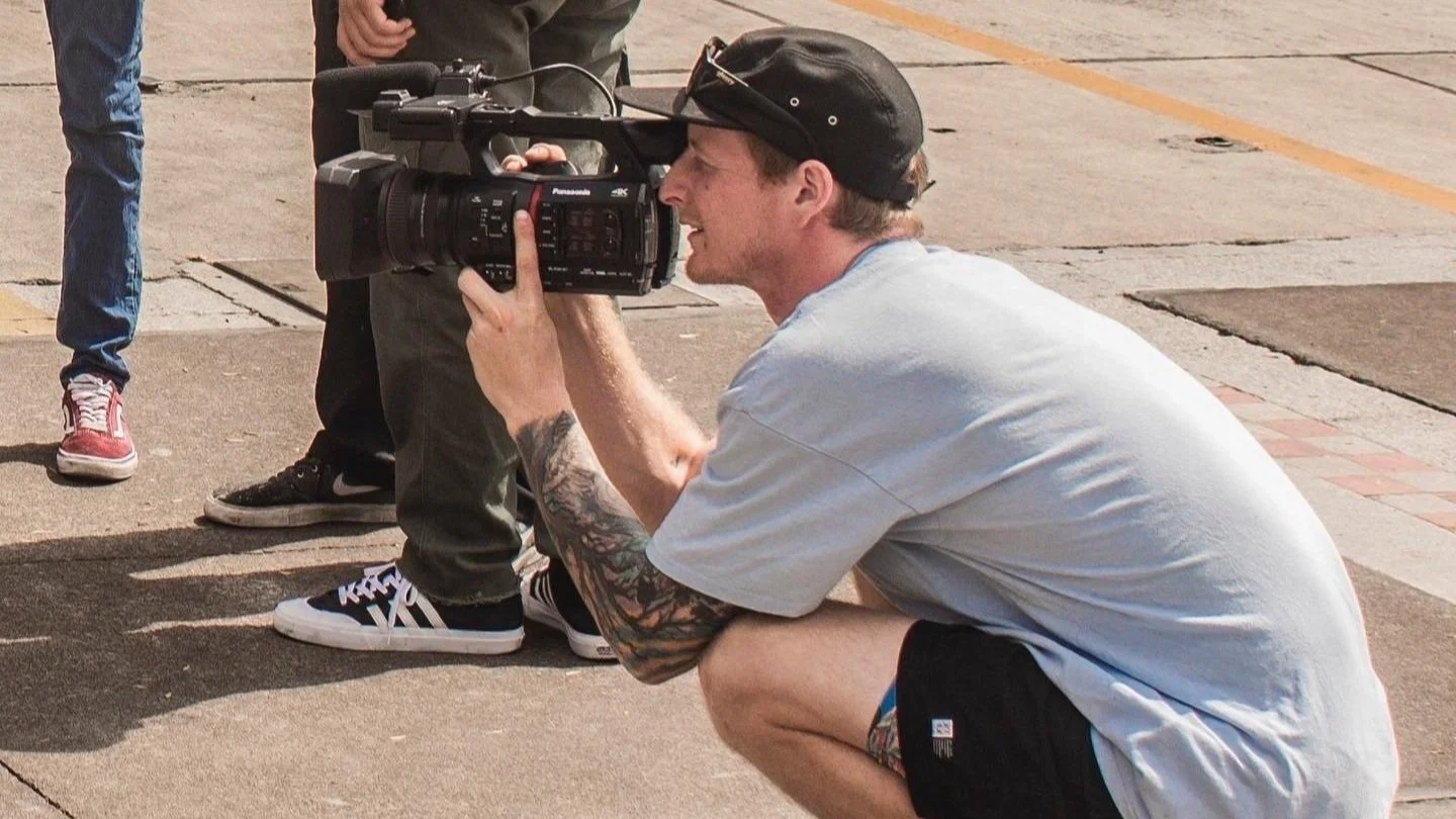 Documentary footage of Clayton Lindley filming freestyle scooter riders competing during the TV Gram event