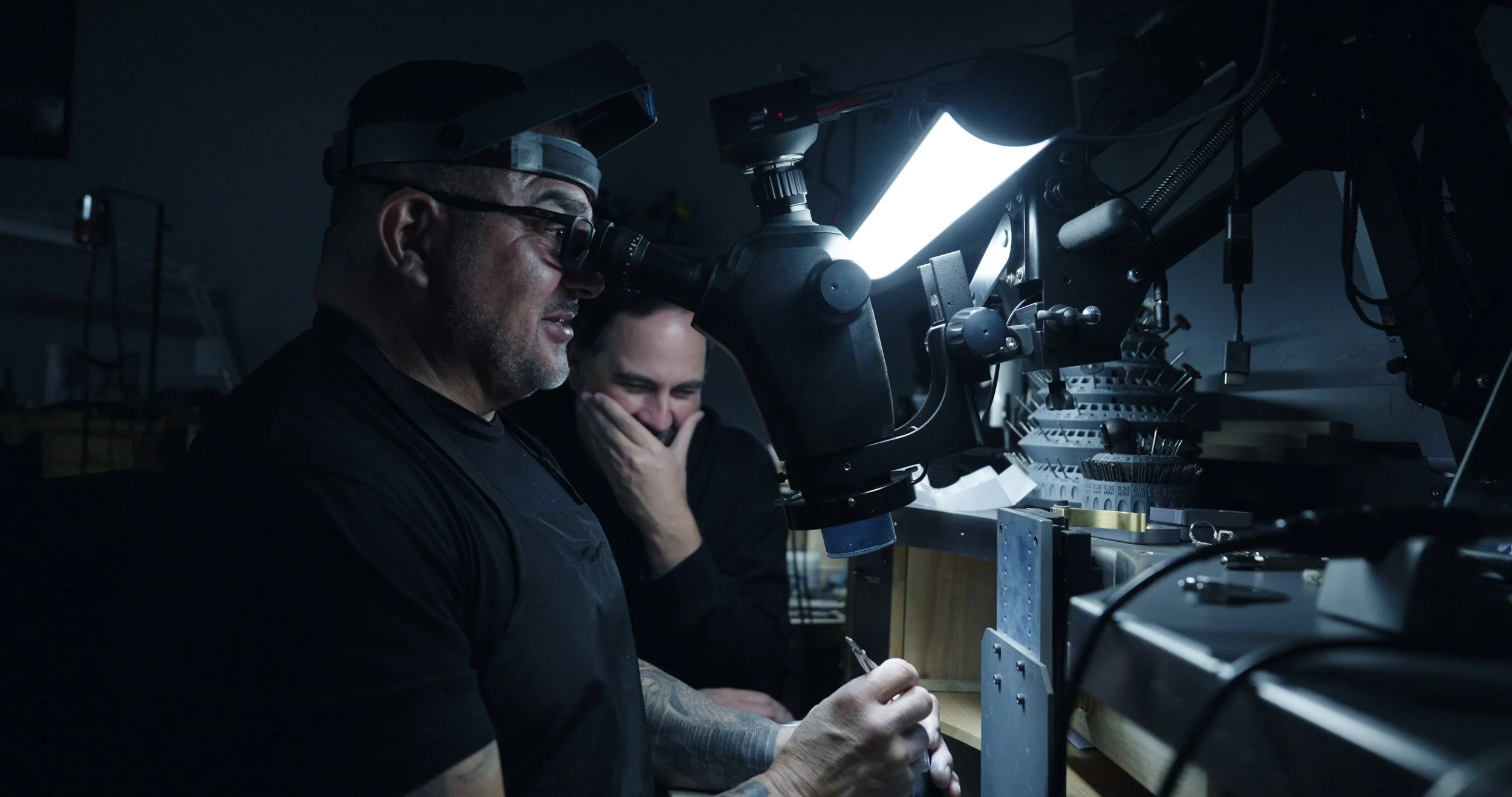 Jeweler inspecting the engagement ring under magnification during the final quality check.