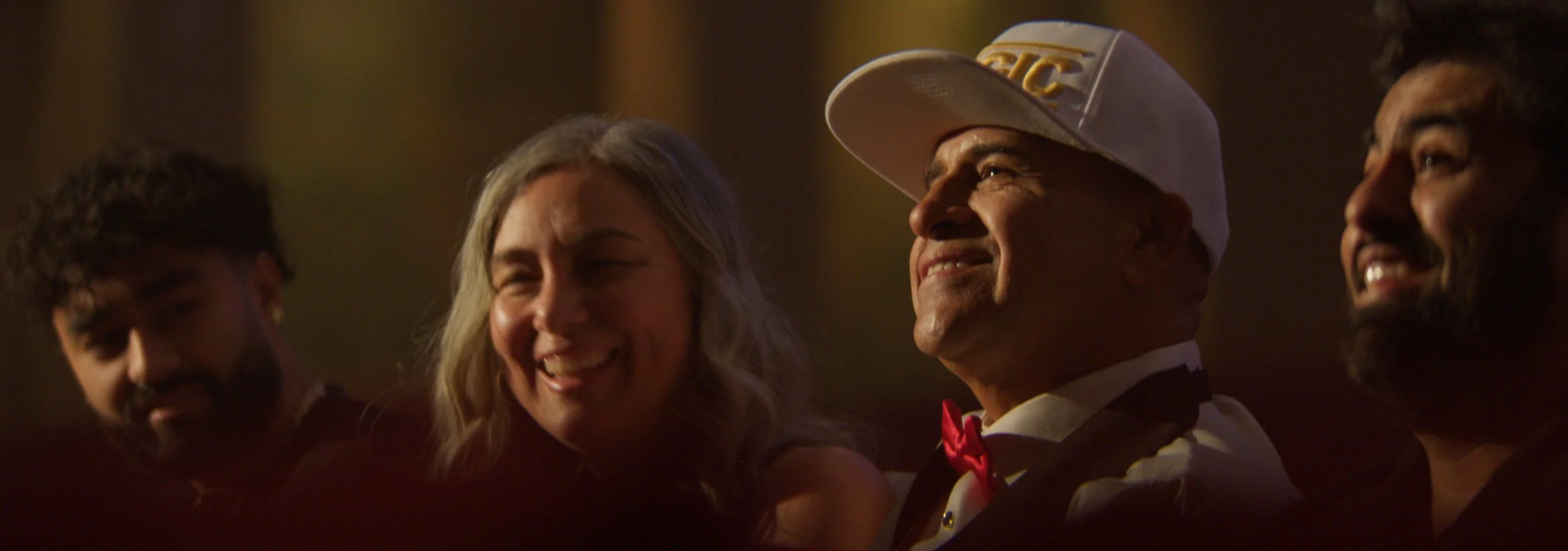 MC Magic and his family watching footage from his past career together during Act 1 of the 30 Years of Magic live performance